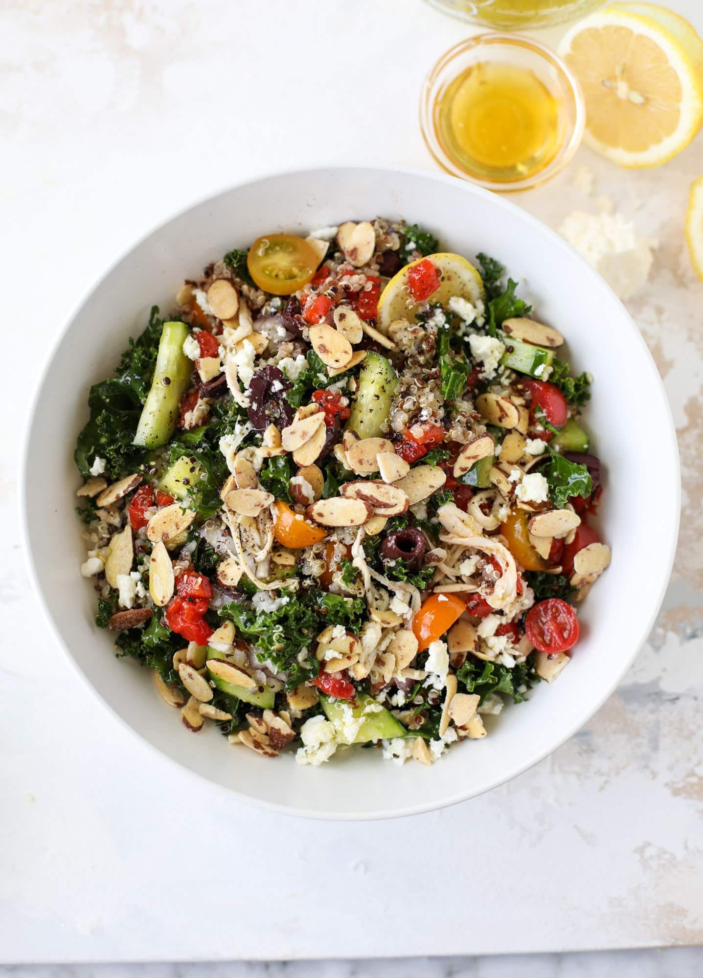 This mediterranean kale and quinoa salad is a copycat for the delicious Panera Bread Modern Greek Salad with Chicken. Super easy and satisfying! I howsweeteats.com #mediterranean #kalesalad