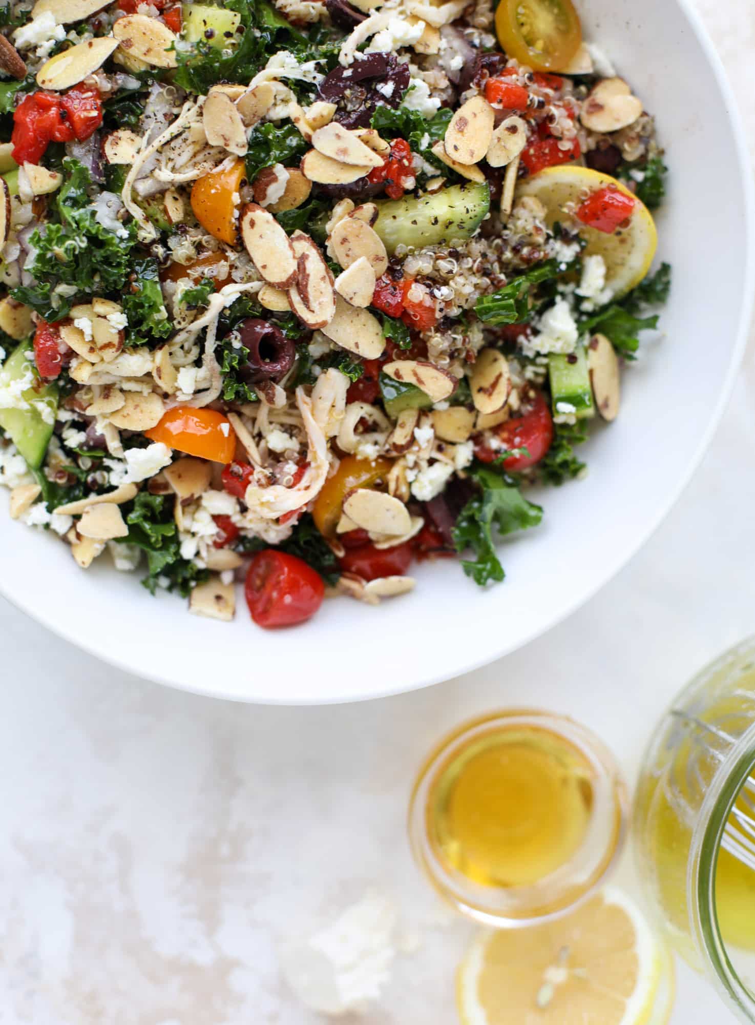 This mediterranean kale and quinoa salad is a copycat for the delicious Panera Bread Modern Greek Salad with Chicken. Super easy and satisfying! I howsweeteats.com #mediterranean #kalesalad