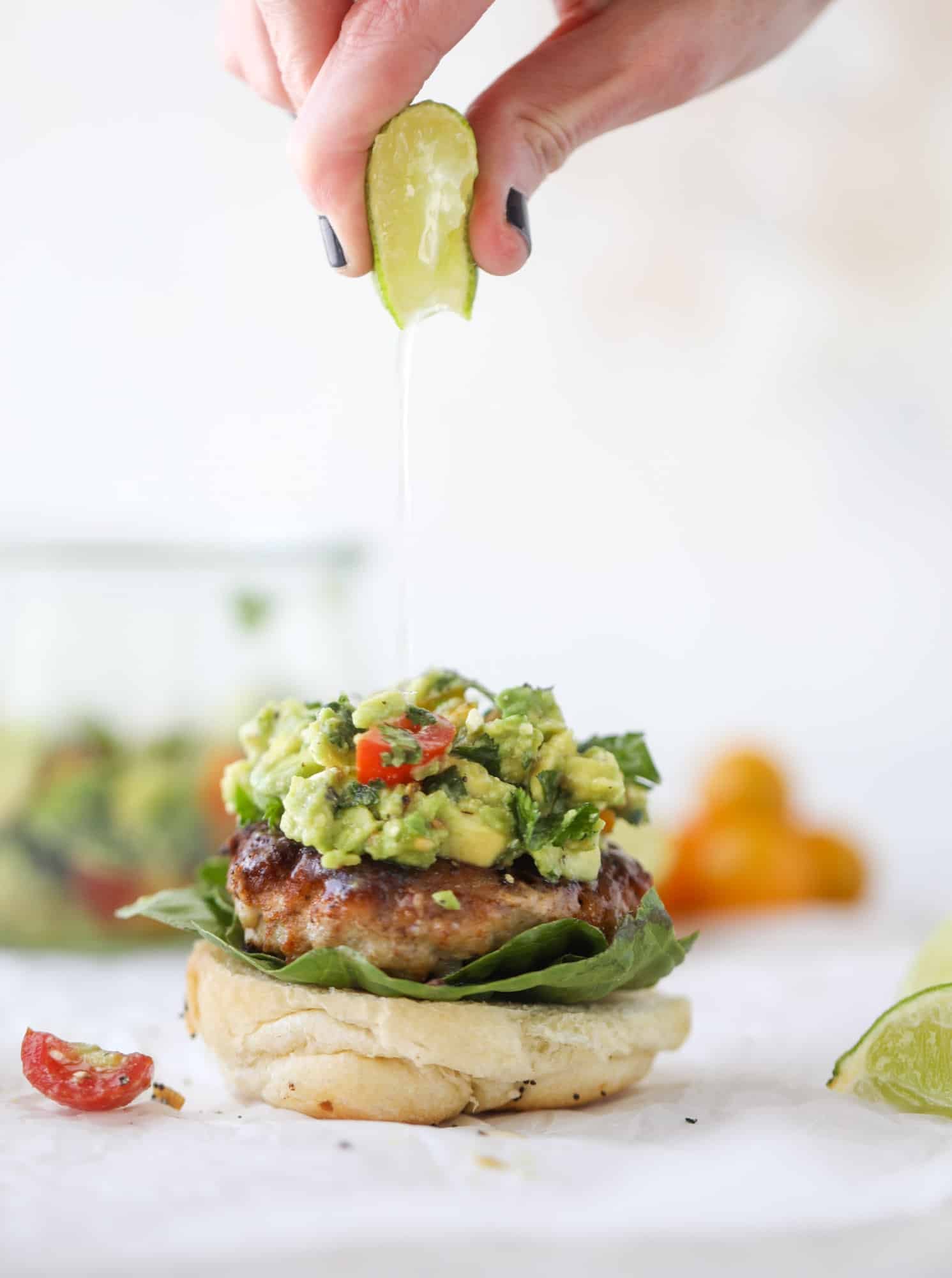 These turkey burgers are full of flavor and topped with a delicious chunky guacamole to take the flavor over the top. The perfect easy dinner! I howsweeteats.com #turkey #burgers