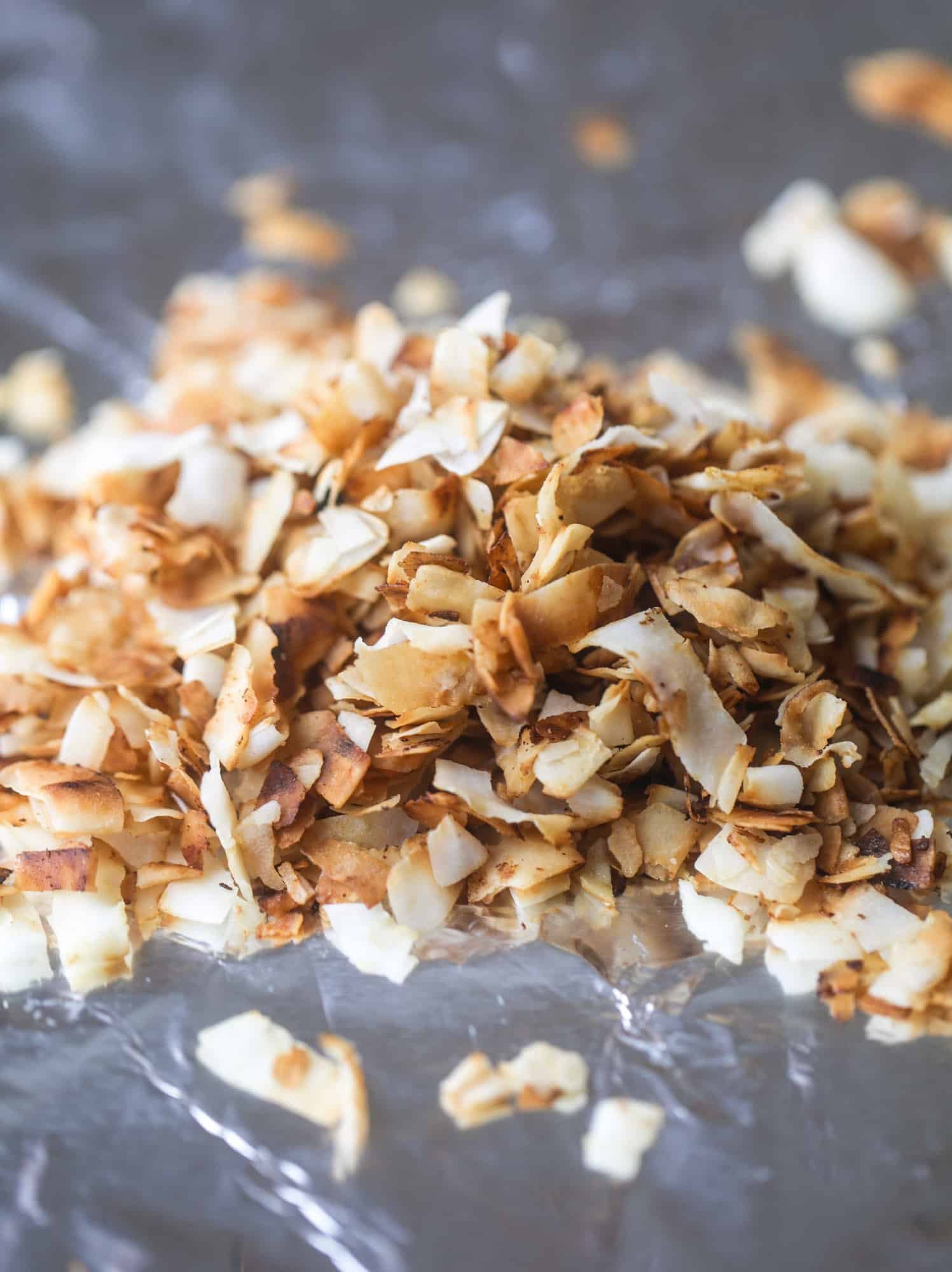 This winter crunch salad is loaded with tons of delicious, crunchy seasonal ingredients. A base of brussels sprouts and kale is topped with sliced apples, satsuma wedges, pomegranate arils, toasted walnuts and savory flaked coconut crunch. Delish! I howsweeteats.com #winter #salad