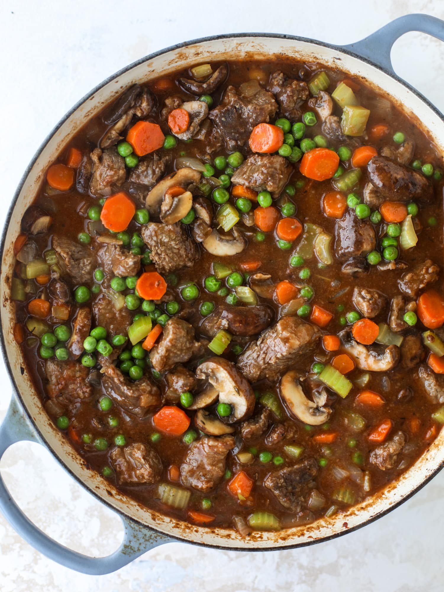 A perfect cold weather comfort food meal, Guiness pot pie has tender, fall-apart beef, lots of vegetables and is topped with buttery beer bread biscuits! I howsweeteats.com #guinness #potpie