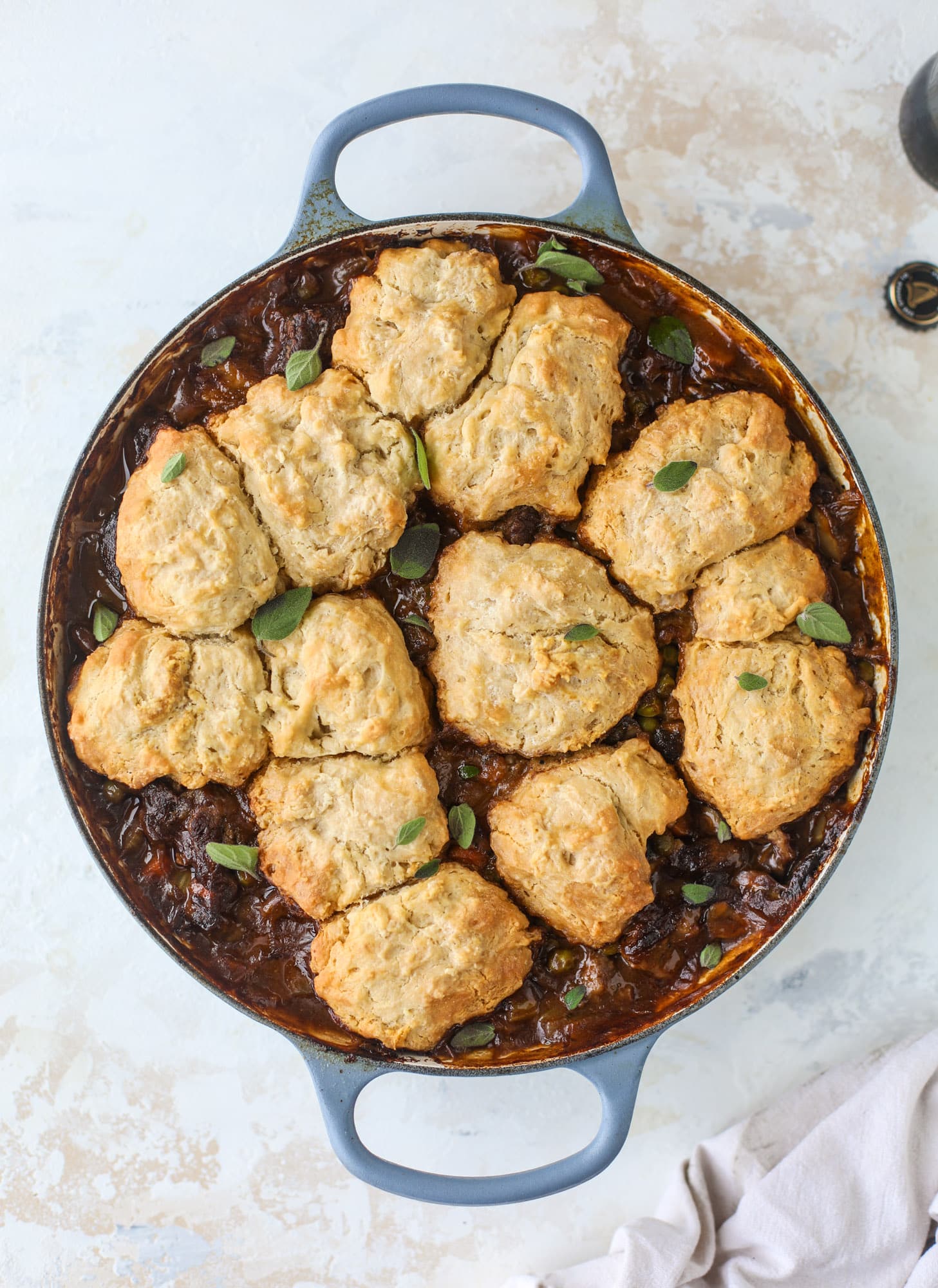 A perfect cold weather comfort food meal, Guiness pot pie has tender, fall-apart beef, lots of vegetables and is topped with buttery beer bread biscuits! I howsweeteats.com #guinness #potpie