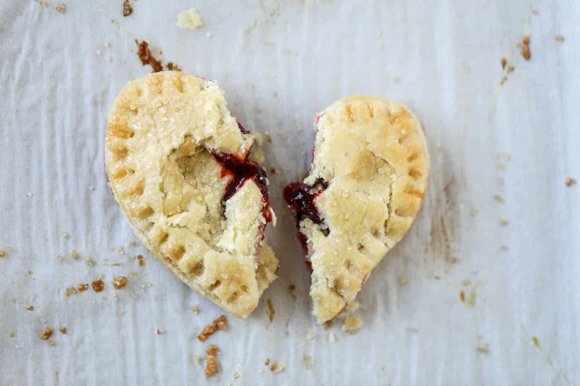 These adorable mini heart pies are filled with a homemade raspberry compote and creamy, chocolatey nutella. So fun and easy to make! I howsweeteats.com #heart #pie