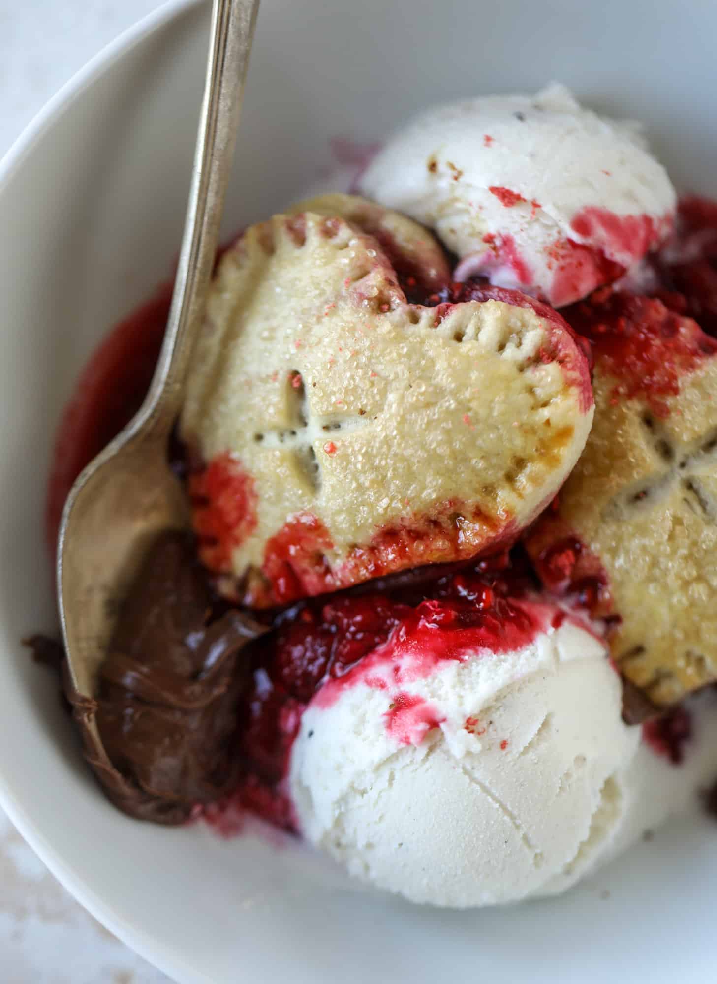 These adorable mini heart pies are filled with a homemade raspberry compote and creamy, chocolatey nutella. So fun and easy to make! I howsweeteats.com #heart #pie