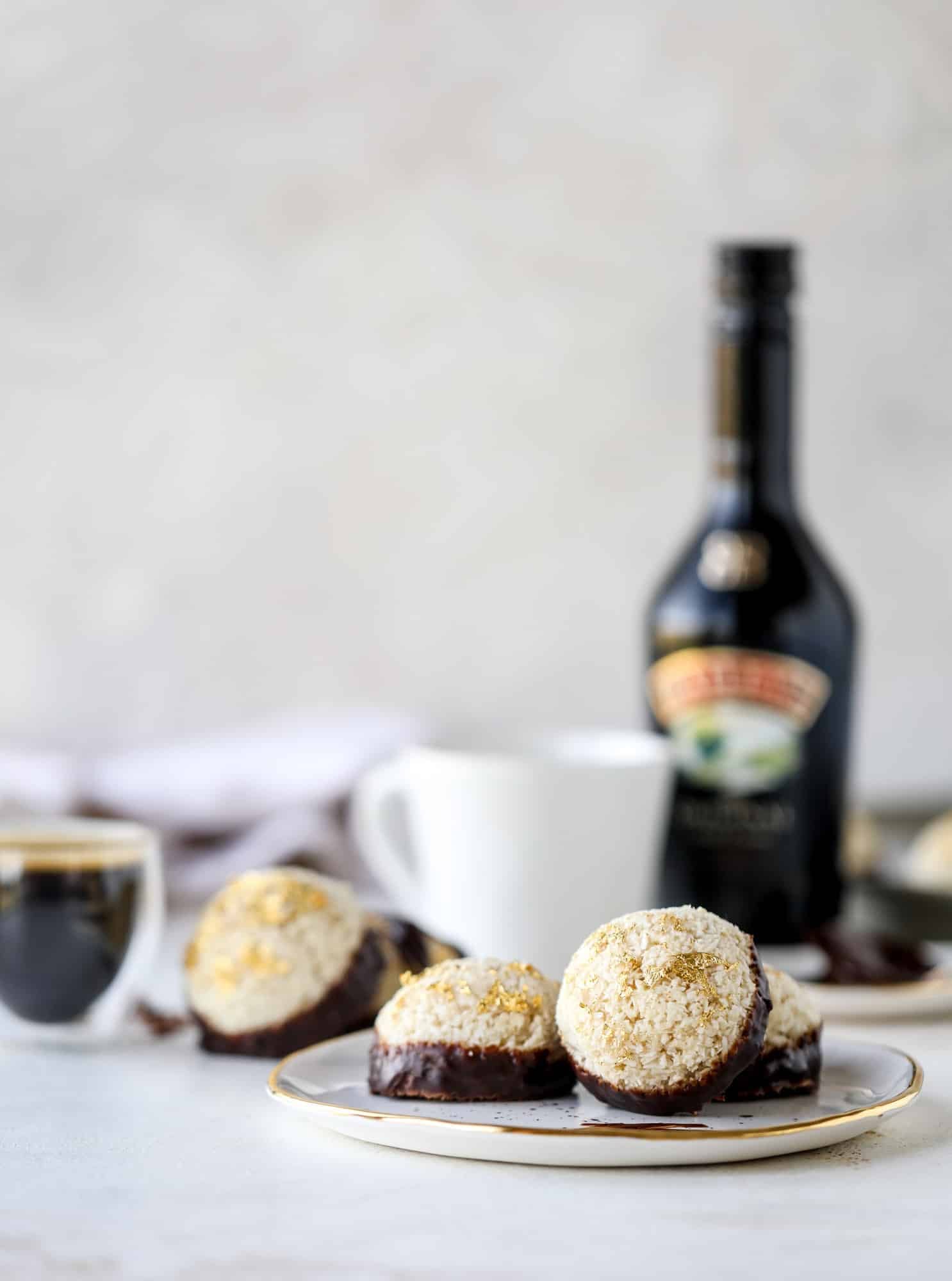 Classic chewy, slightly gooey coconut macaroons dipped in an irish cream chocolate ganache. Easy to make and gluten free too! I howsweeteats.com #irishcream #coconutmacaroons