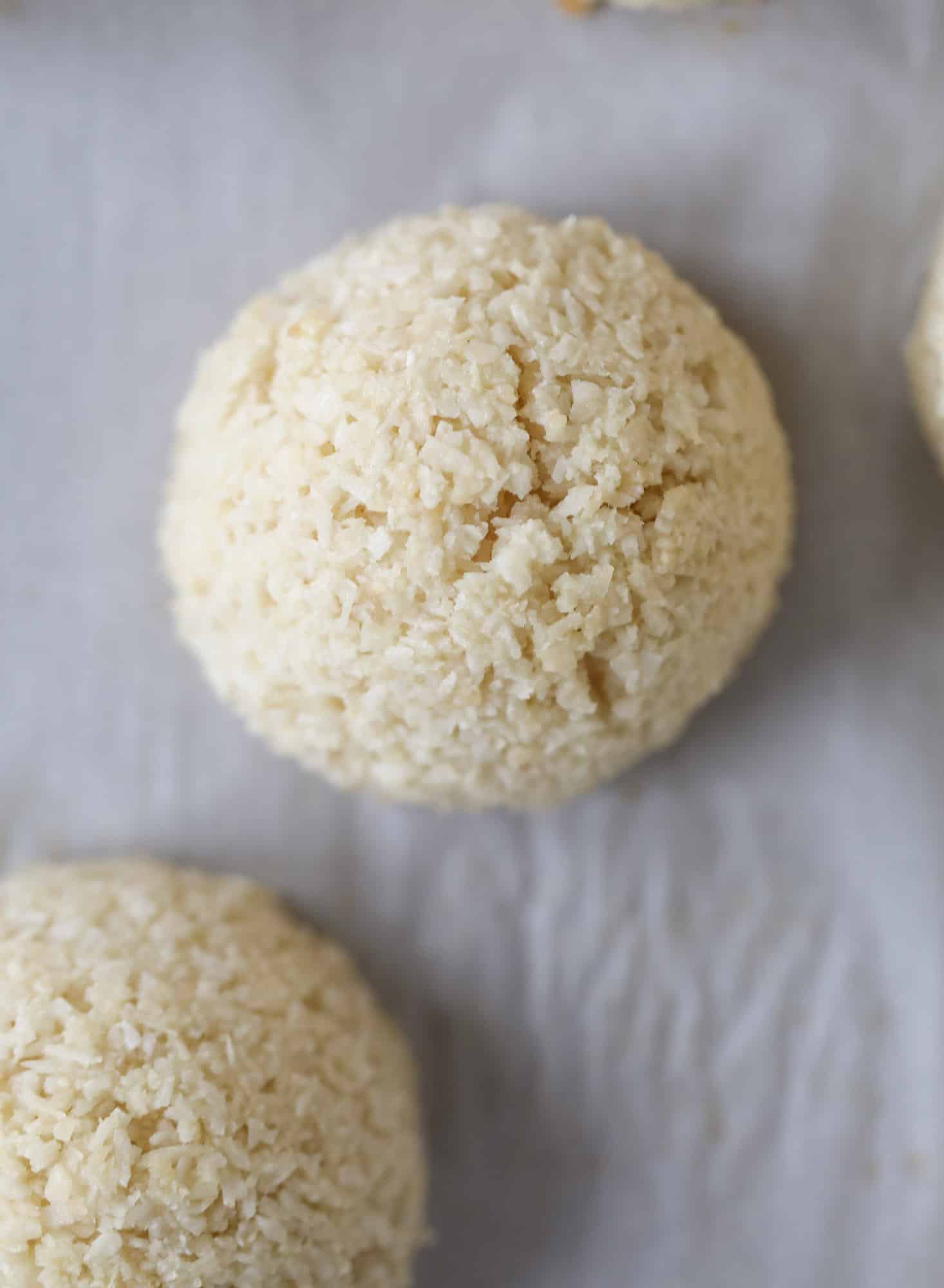 Classic chewy, slightly gooey coconut macaroons dipped in an irish cream chocolate ganache. Easy to make and gluten free too! I howsweeteats.com #irishcream #coconutmacaroons