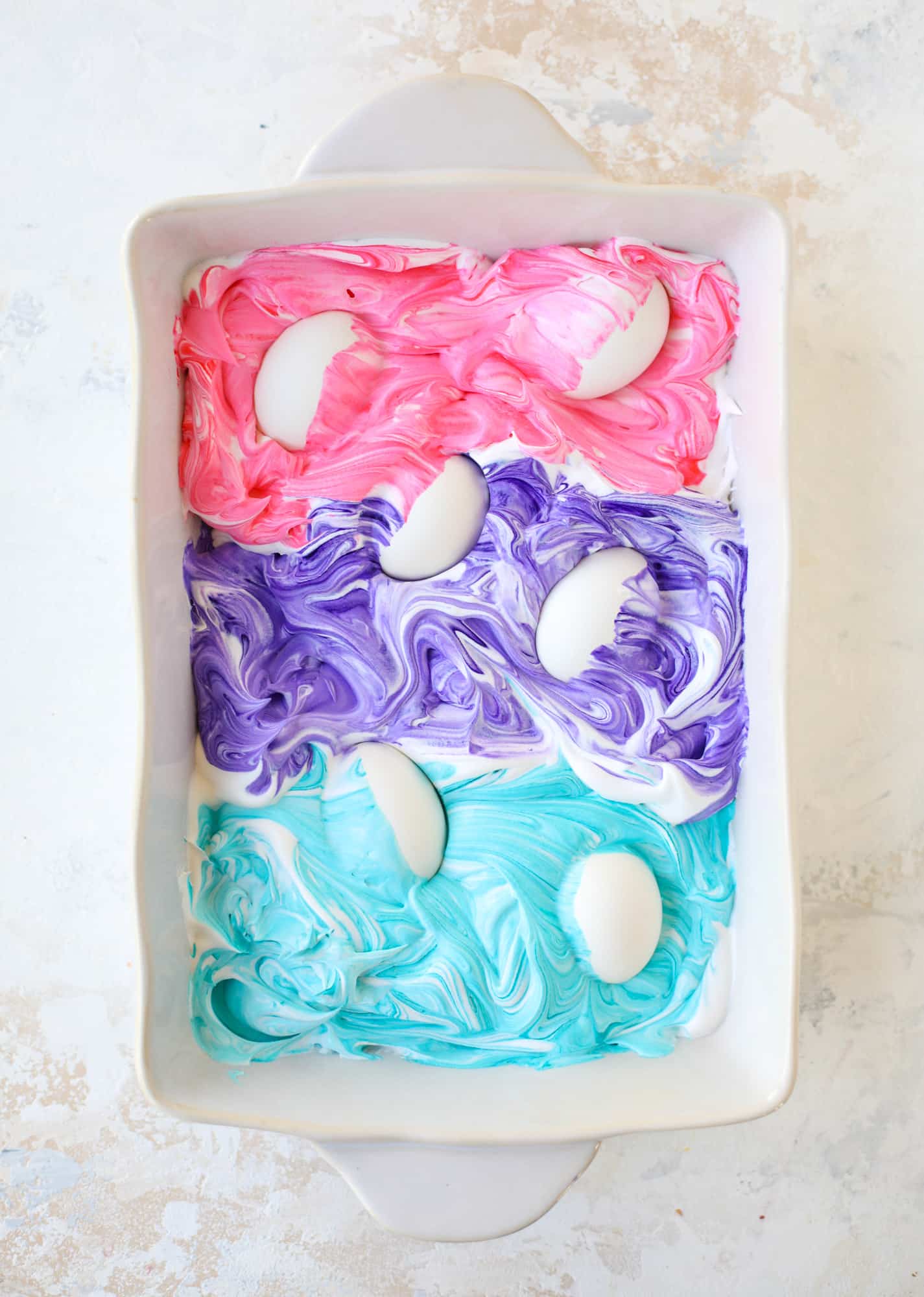 This is how to dye eggs with cool whip! It's so fun, super kid-friendly and ridiculously easy too. I love using this method to make unicorn eggs!