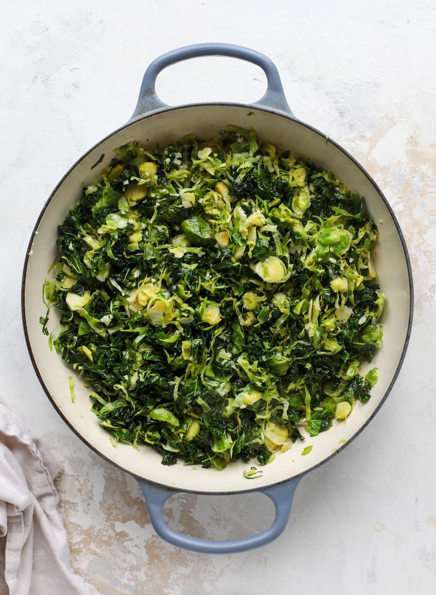 This brussels spaghetti with kale, parmesan and pine nuts is a super flavorful, quick and easy weeknight meal. You can add in a protein if you wish! I howsweeteats.com #brussels #spaghetti