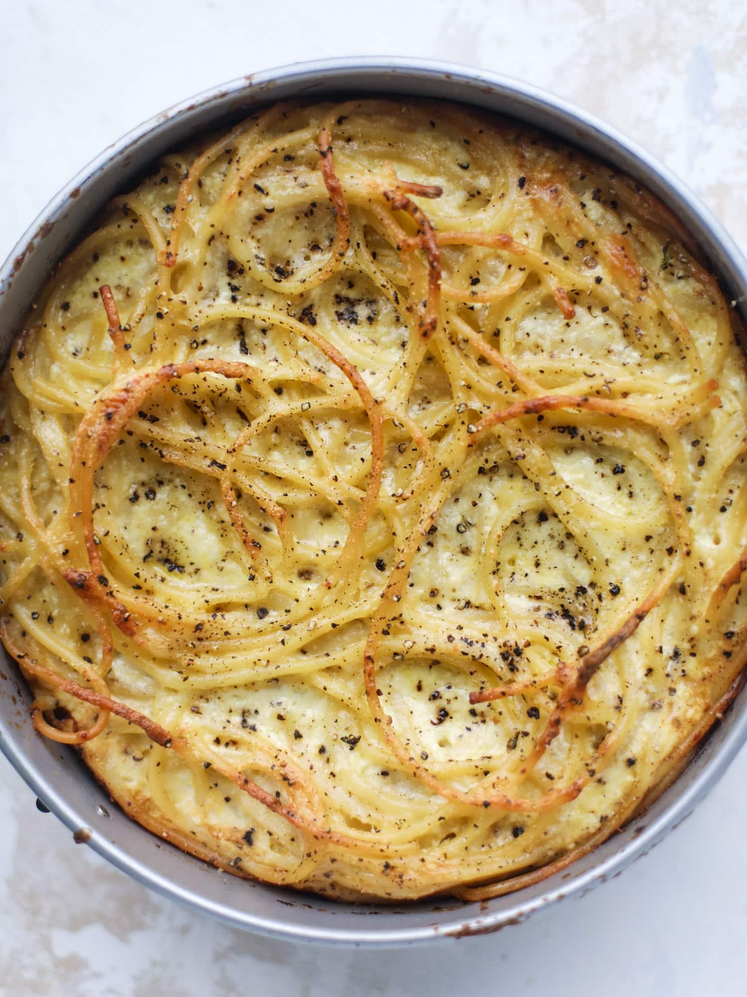 Hello lover! Cacio e pepe pie is made with parmigiano-reggiano cheese, black pepper and bucatini pasta. Baked until cheese and bubbly, it's to die for.