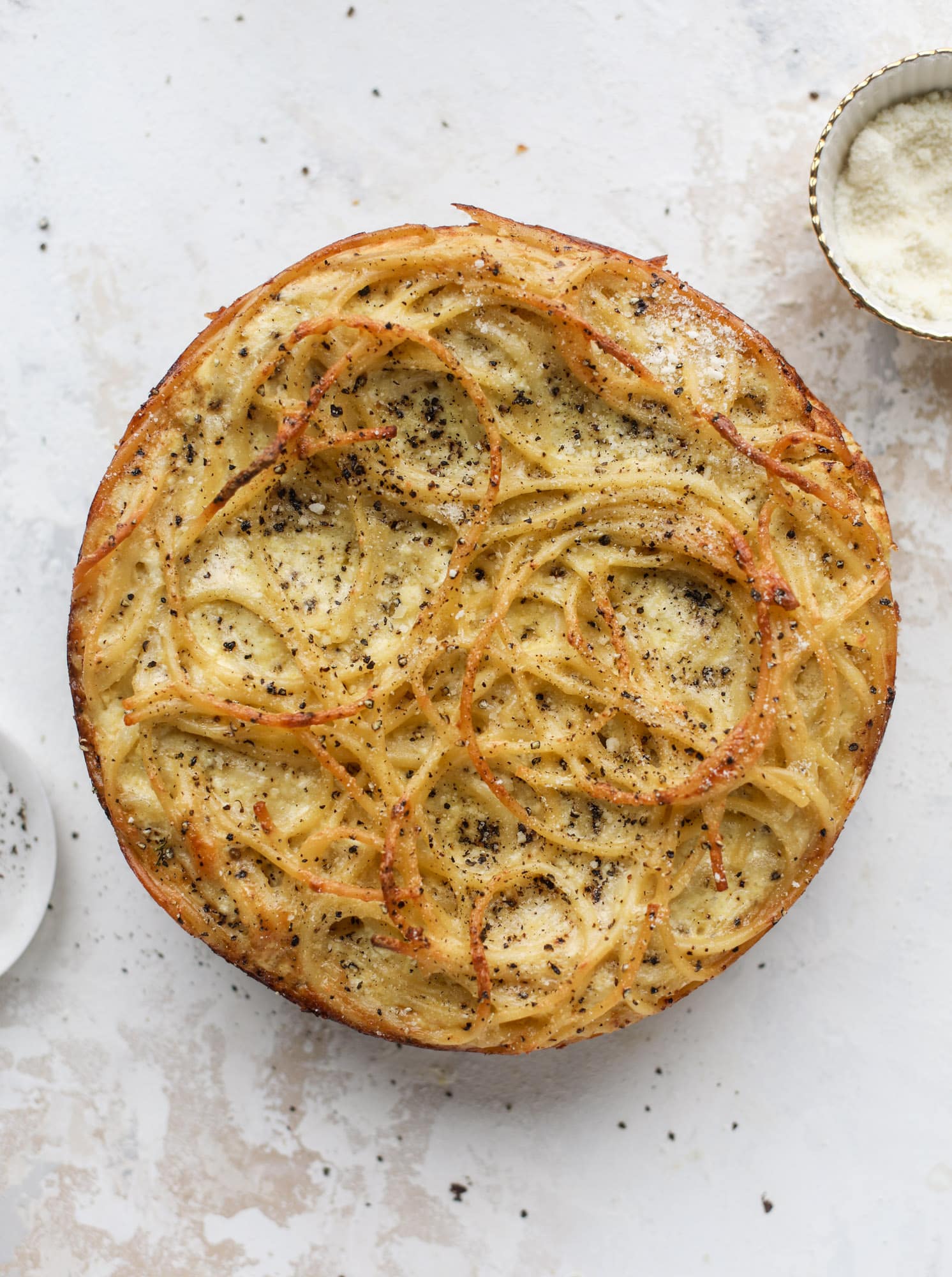 Hello lover! Cacio e pepe pie is made with parmigiano-reggiano cheese, black pepper and bucatini pasta. Baked until cheese and bubbly, it's to die for.