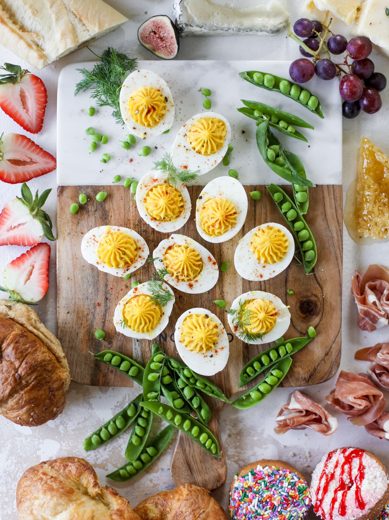 The highlight of this Easter brunch board are the deviled eggs and soft boiled eggs! Add some avocado toast, donuts and bloody marys and you've arrived. I howsweeteats.com #brunch #board
