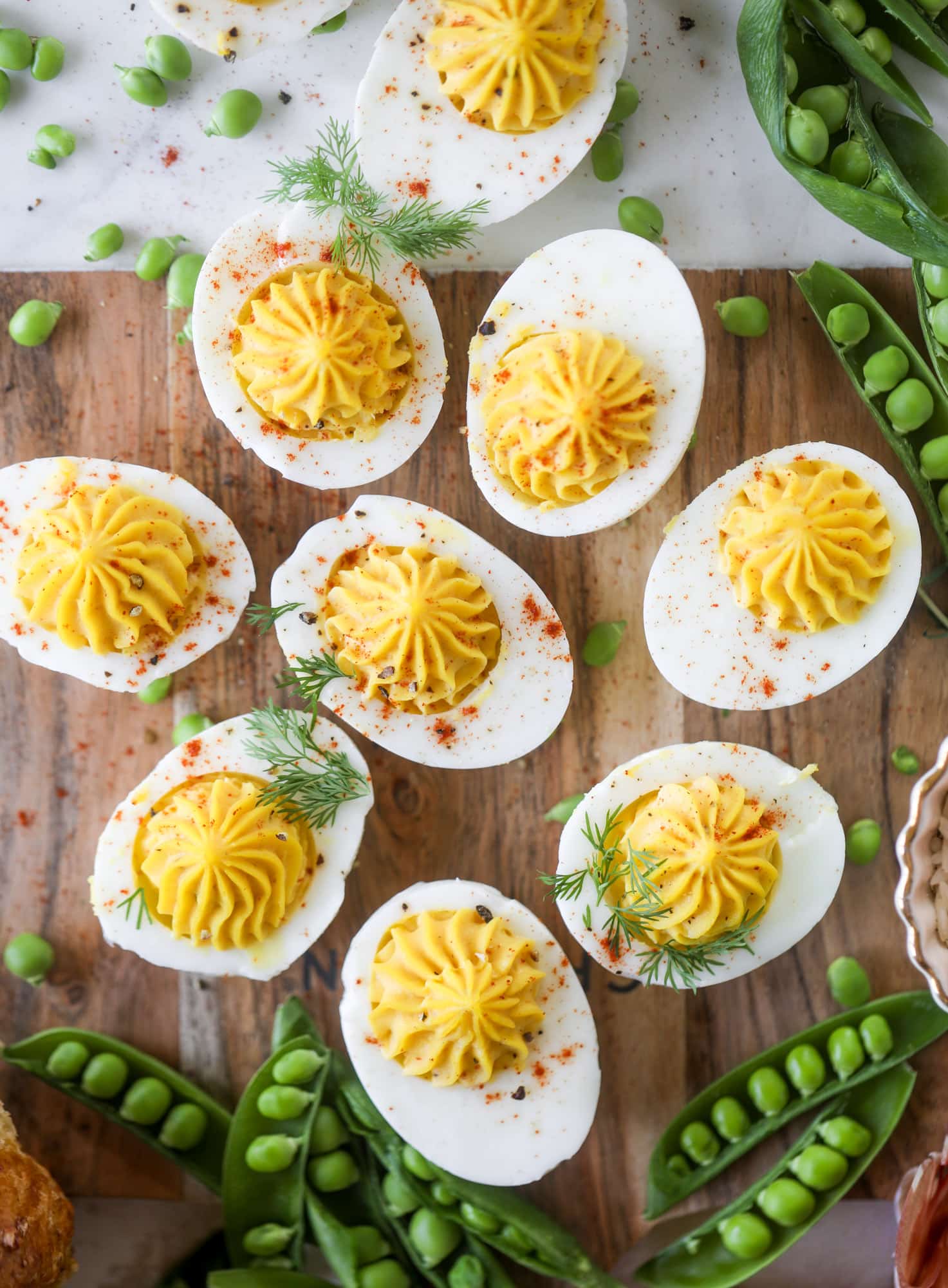 The highlight of this Easter brunch board are the deviled eggs and soft boiled eggs! Add some avocado toast, donuts and bloody marys and you've arrived. I howsweeteats.com #brunch #board
