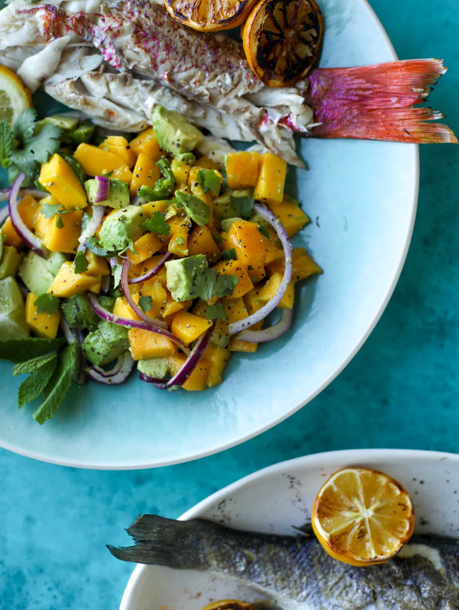Grilled whole fish is easier than it looks! Try this recipe for the butteriest, most flavorful grilled branzino paired with an avocado mango salad.