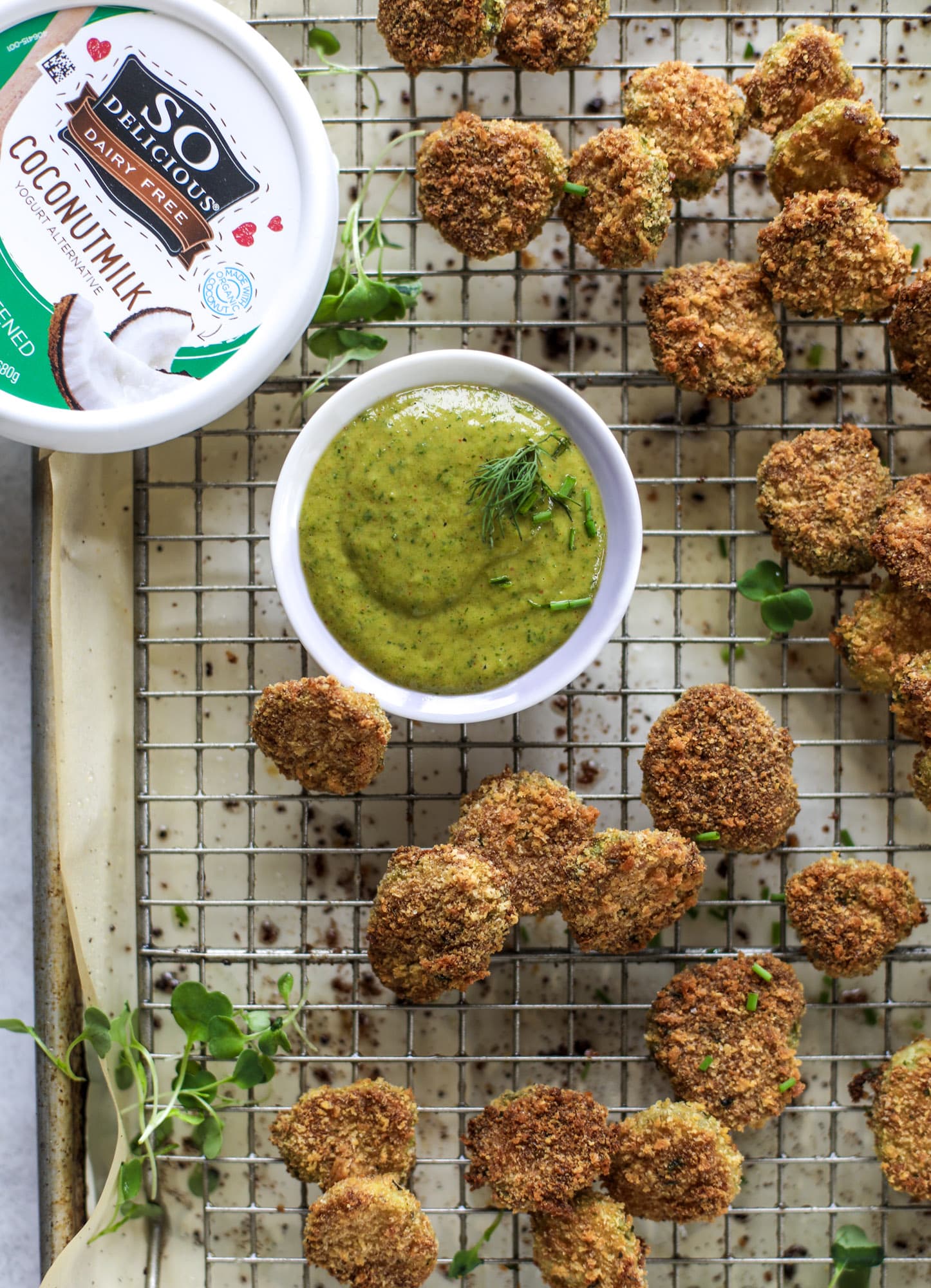 Oven fried crispy pickles are super crunchy and delicious! Served with a dairy free green goddess ranch dip, they are the best snack ever.