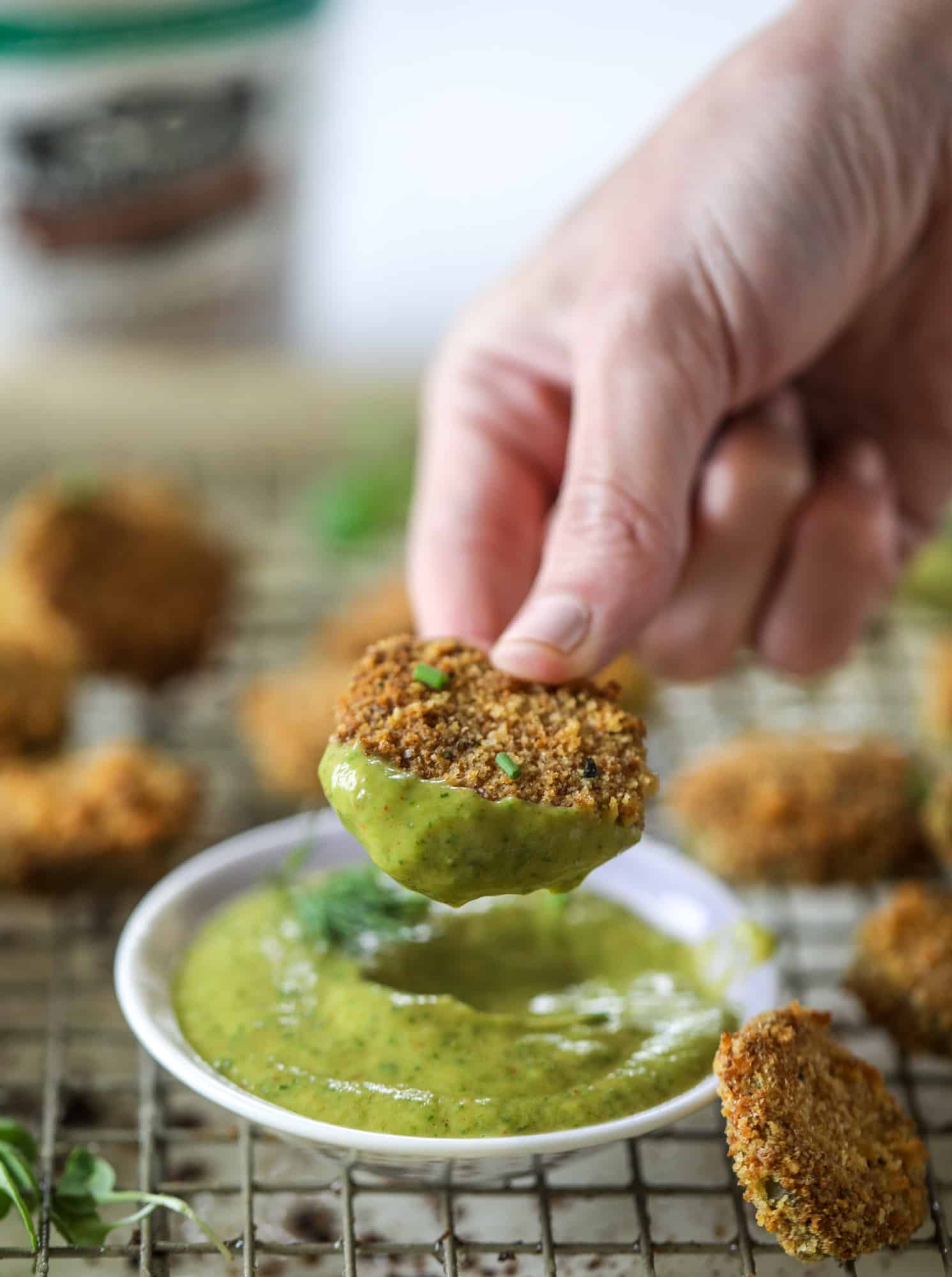 Oven fried crispy pickles are super crunchy and delicious! Served with a dairy free green goddess ranch dip, they are the best snack ever.