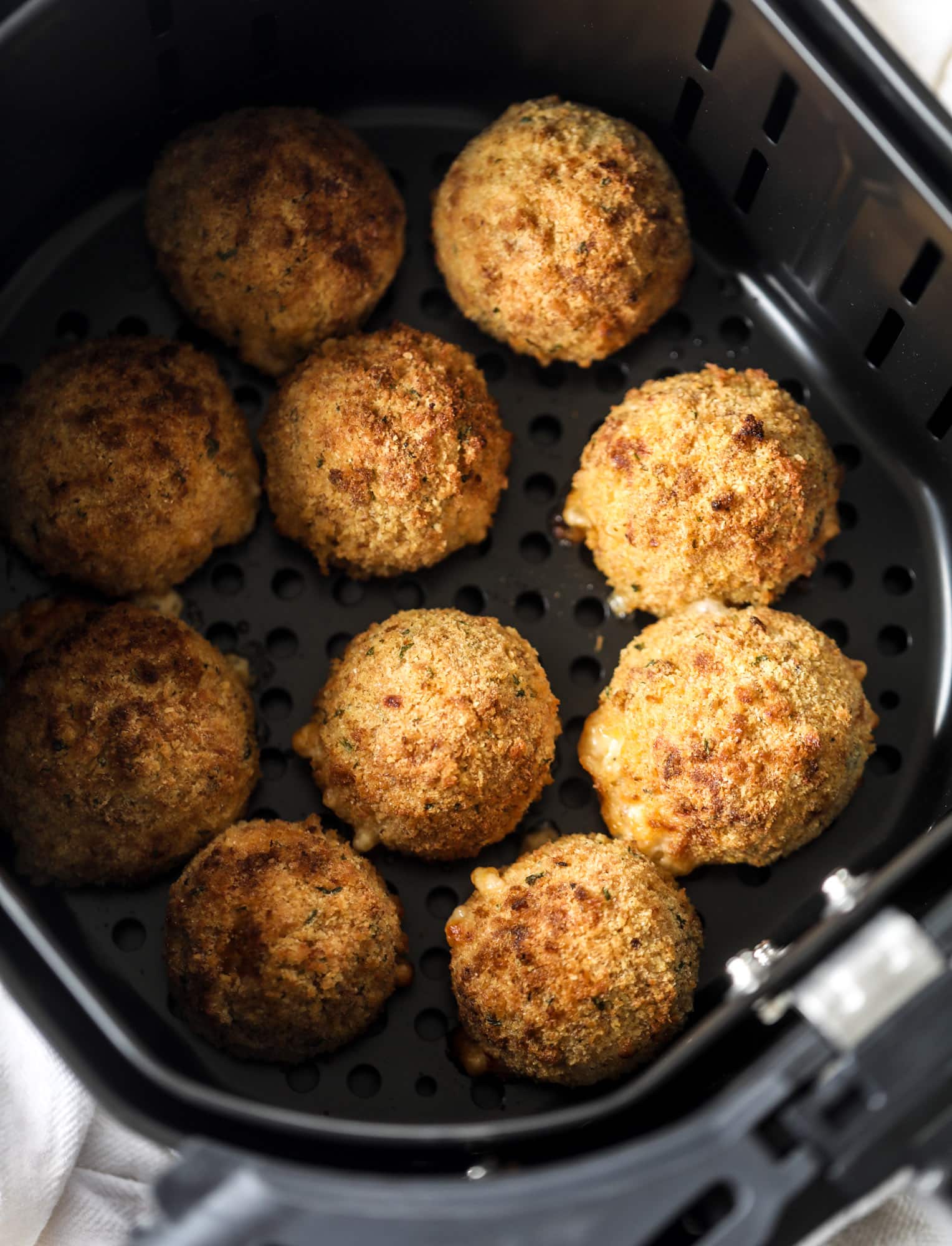 This cheesy cauliflower rice arancini is every bit as delicious as traditional arancini, and so much lighter! Cheesy on the side, crunchy on the outside.