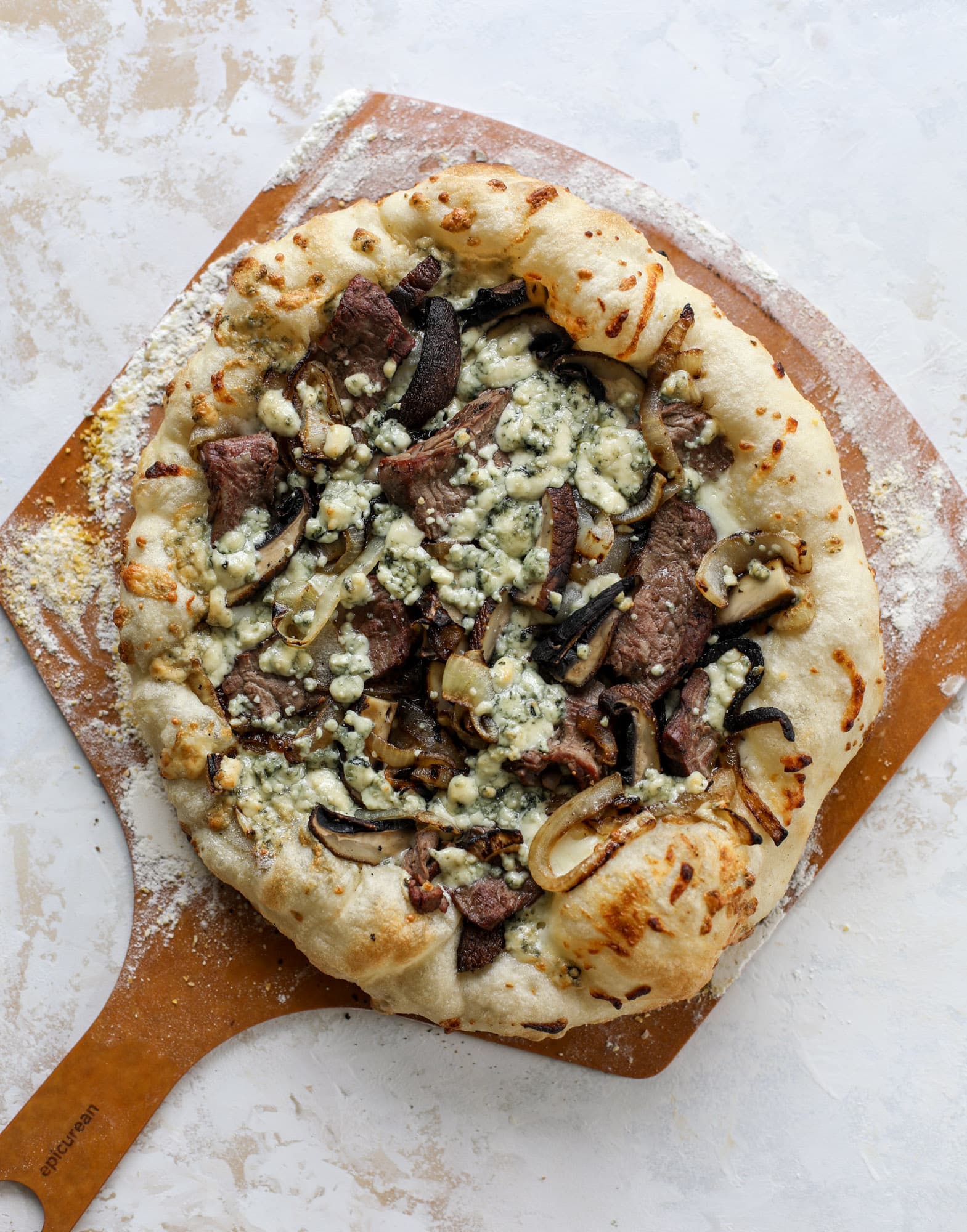 This grilled steakhouse pizza has all the amazing smoky flavors of your favorite steakhouse. Grilled onions, mushrooms and creamy gorgonzola finish it off.