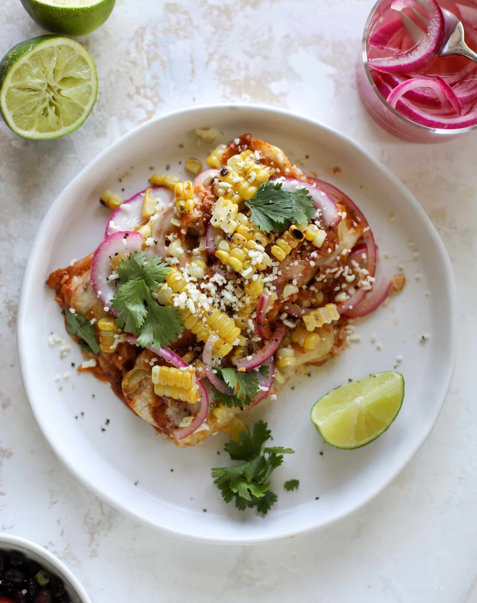 These grilled corn enchiladas are the perfect summer meal! Grilled corn, zucchini, homemade sauce and cheese come together for a flavor explosion!