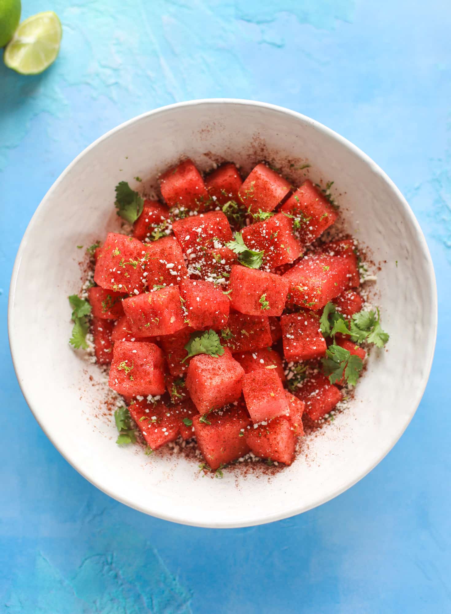 This chili lime watermelon is the perfect summer snack! It's savory and sweet with crumbled cotija cheese and lots of lime. Delish!