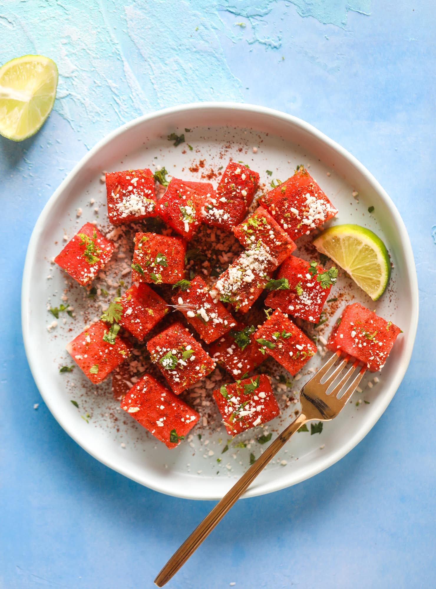 This chili lime watermelon is the perfect summer snack! It's savory and sweet with crumbled cotija cheese and lots of lime. Delish!