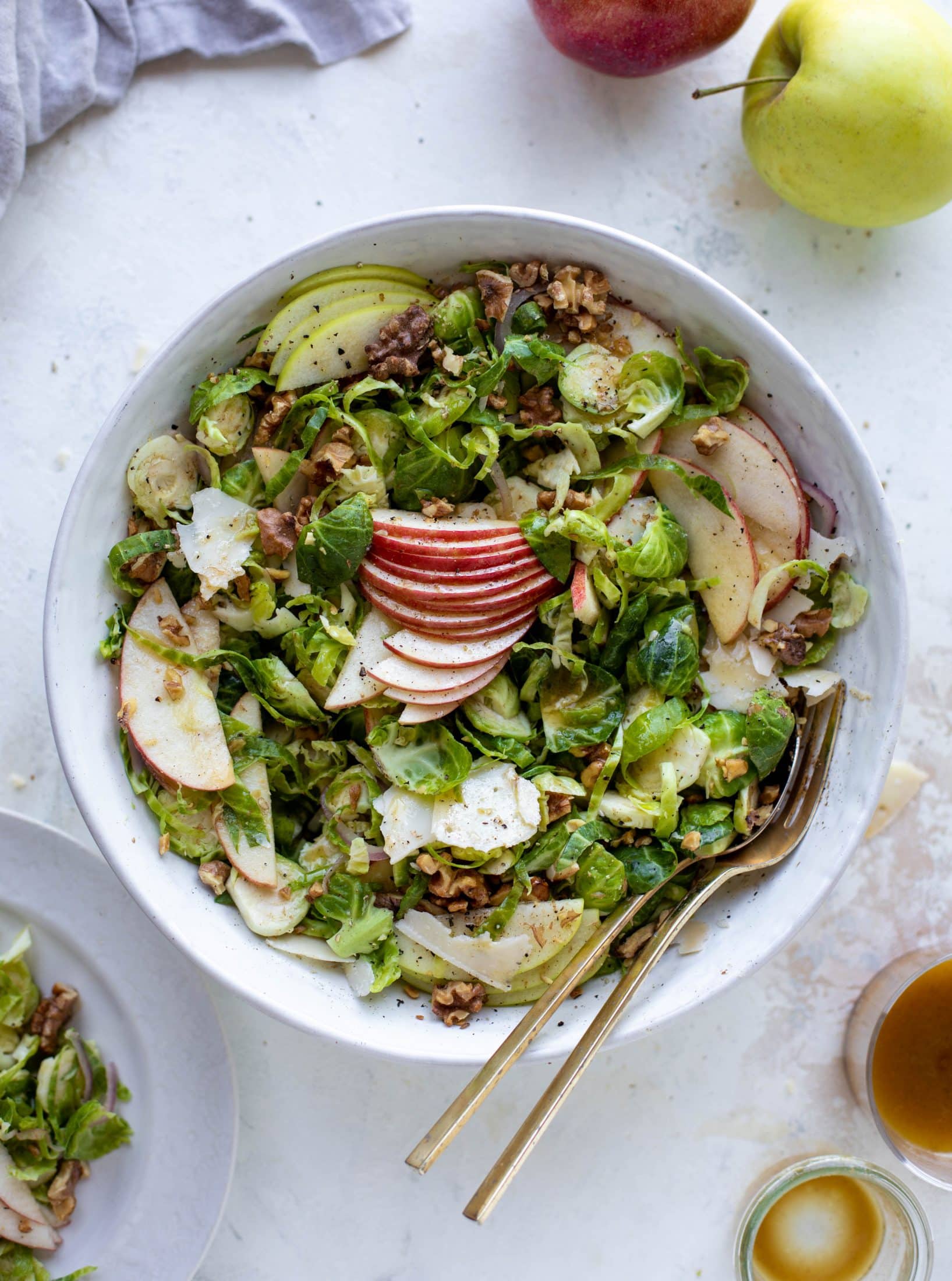 This crunchy brussels sprouts apple salad is filled with sprouts, apples, shallots, cinnamon toasted walnuts and drizzled with a brown butter dressing.