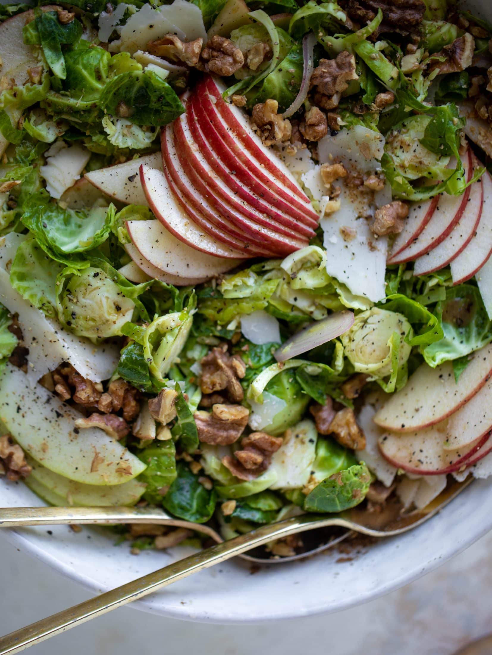 This crunchy brussels sprouts apple salad is filled with sprouts, apples, shallots, cinnamon toasted walnuts and drizzled with a brown butter dressing.