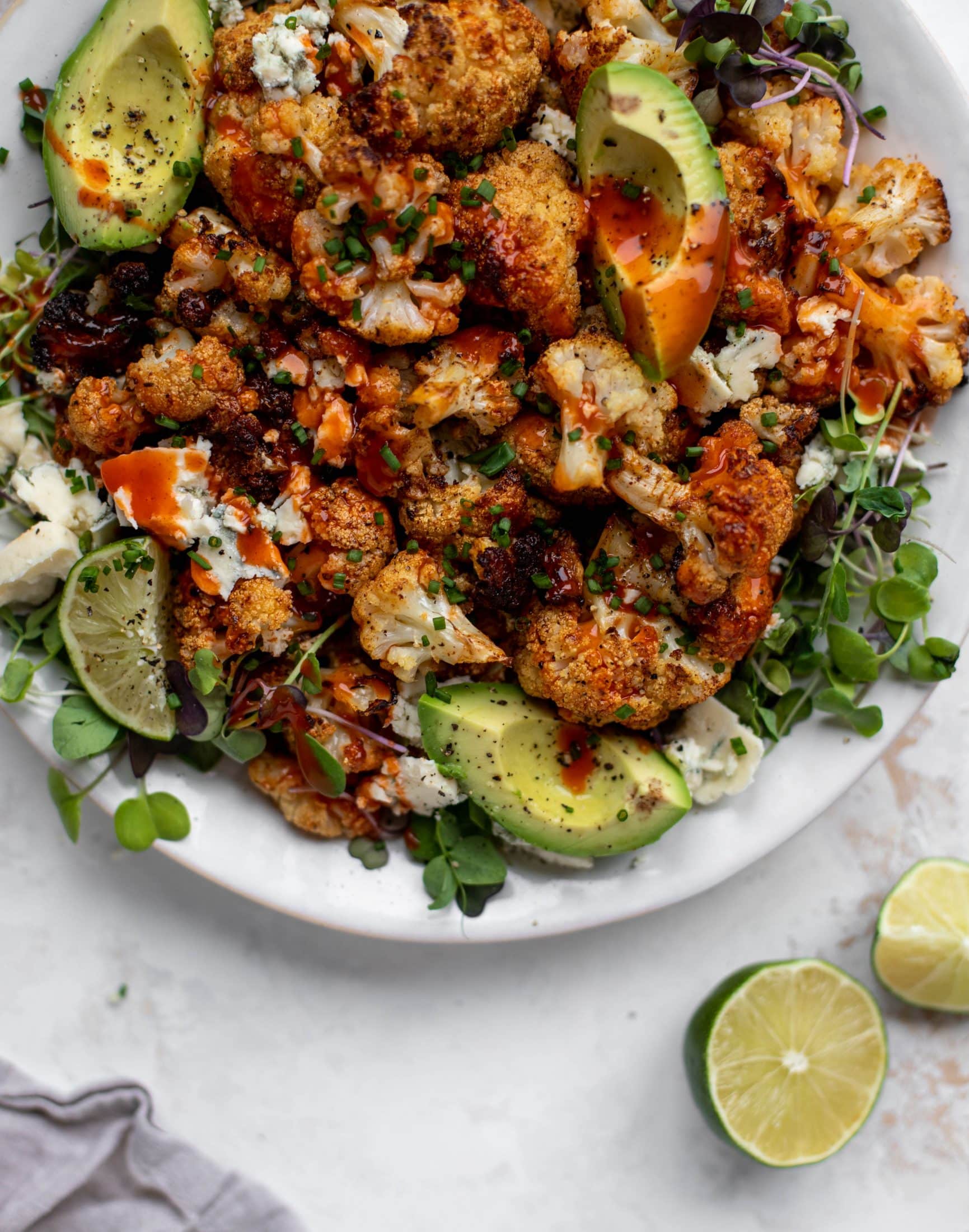 This crispy buffalo cauliflower is loaded with flavor! Serve with avocado and smoked blue cheese - you will want to eat this everyday!