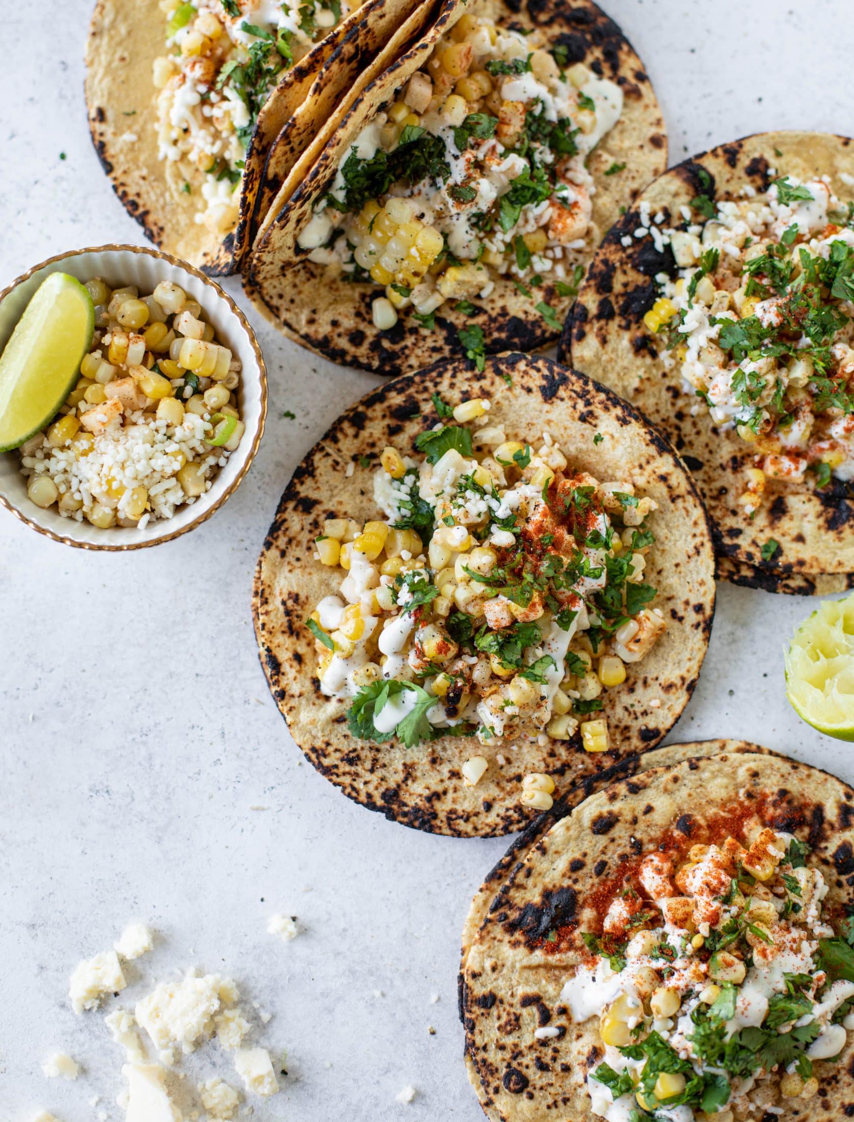 These street corn tacos are filled with a jicama corn salad and drizzled with garlic mayo. This little taco packs a major flavor punch.