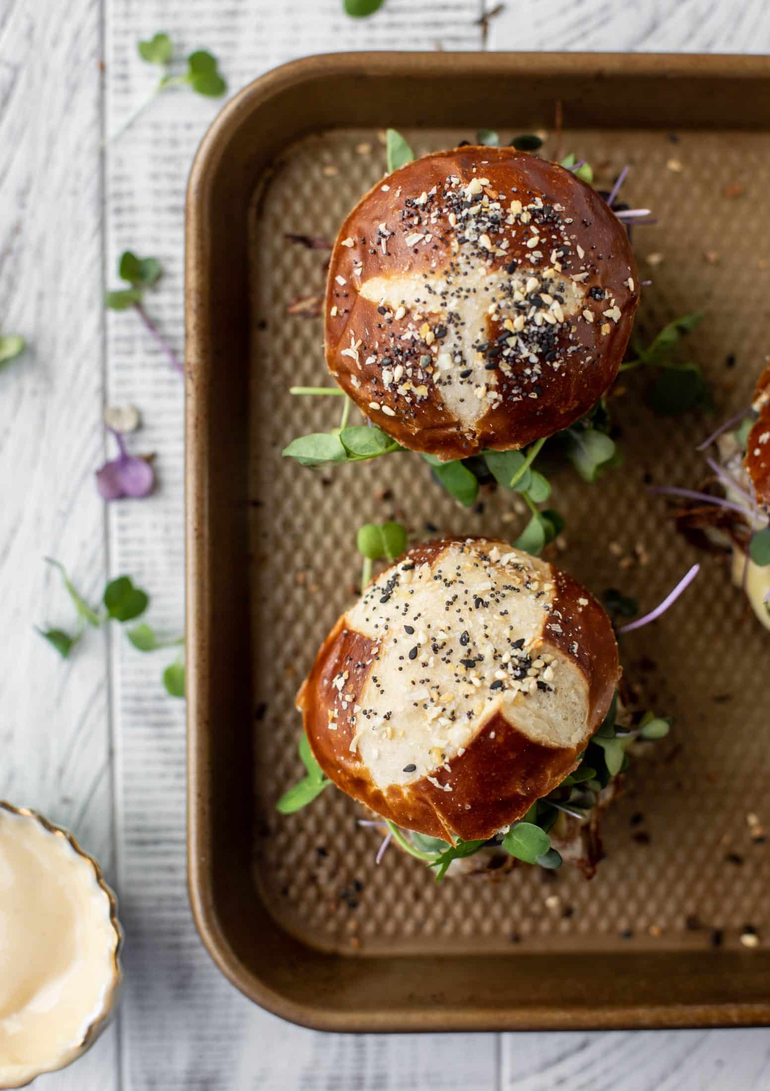 This pumpkin beer brisket melts are smothered in havarti cheese and served on everything pretzel rolls. They are ridiculously delicious!