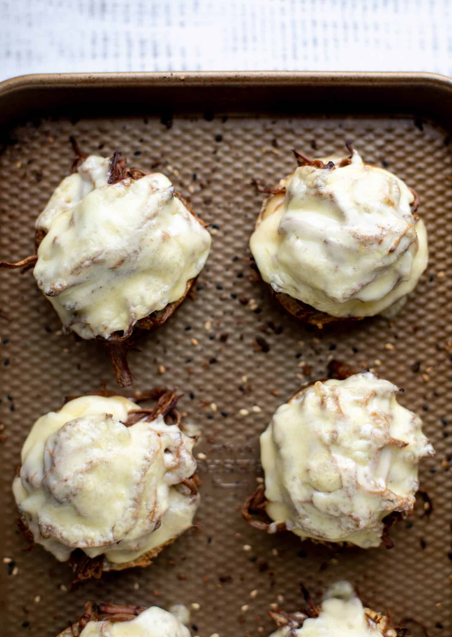 This pumpkin beer brisket melts are smothered in havarti cheese and served on everything pretzel rolls. They are ridiculously delicious!