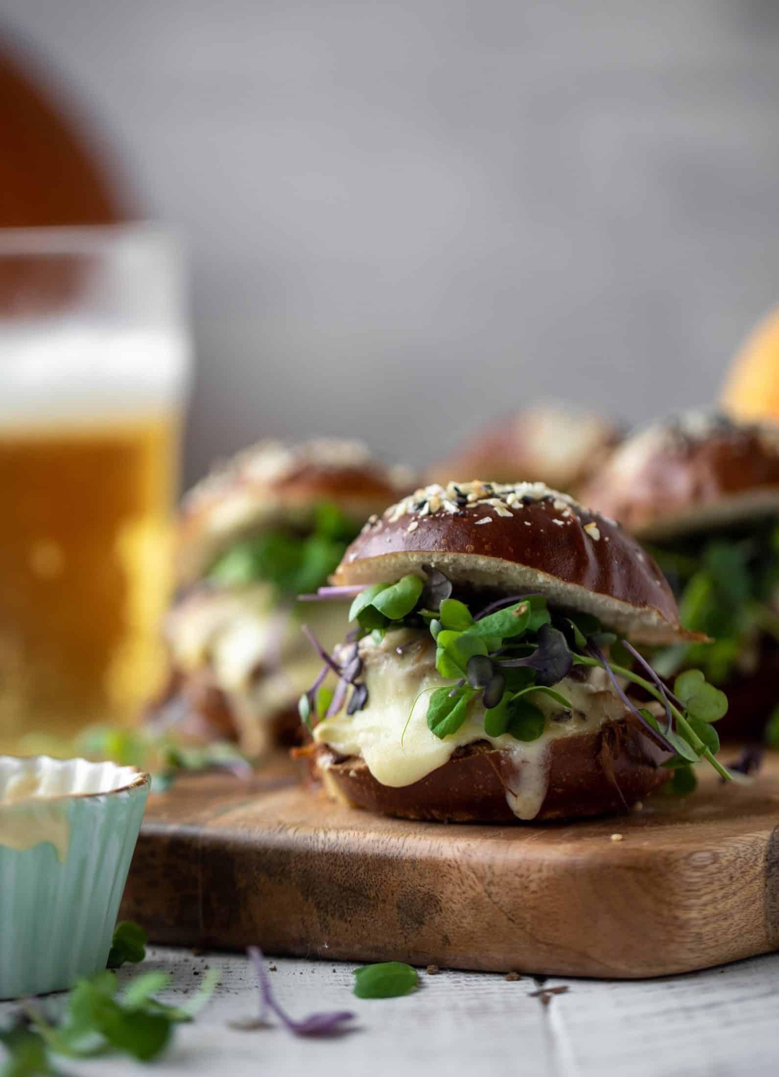 This pumpkin beer brisket melts are smothered in havarti cheese and served on everything pretzel rolls. They are ridiculously delicious!