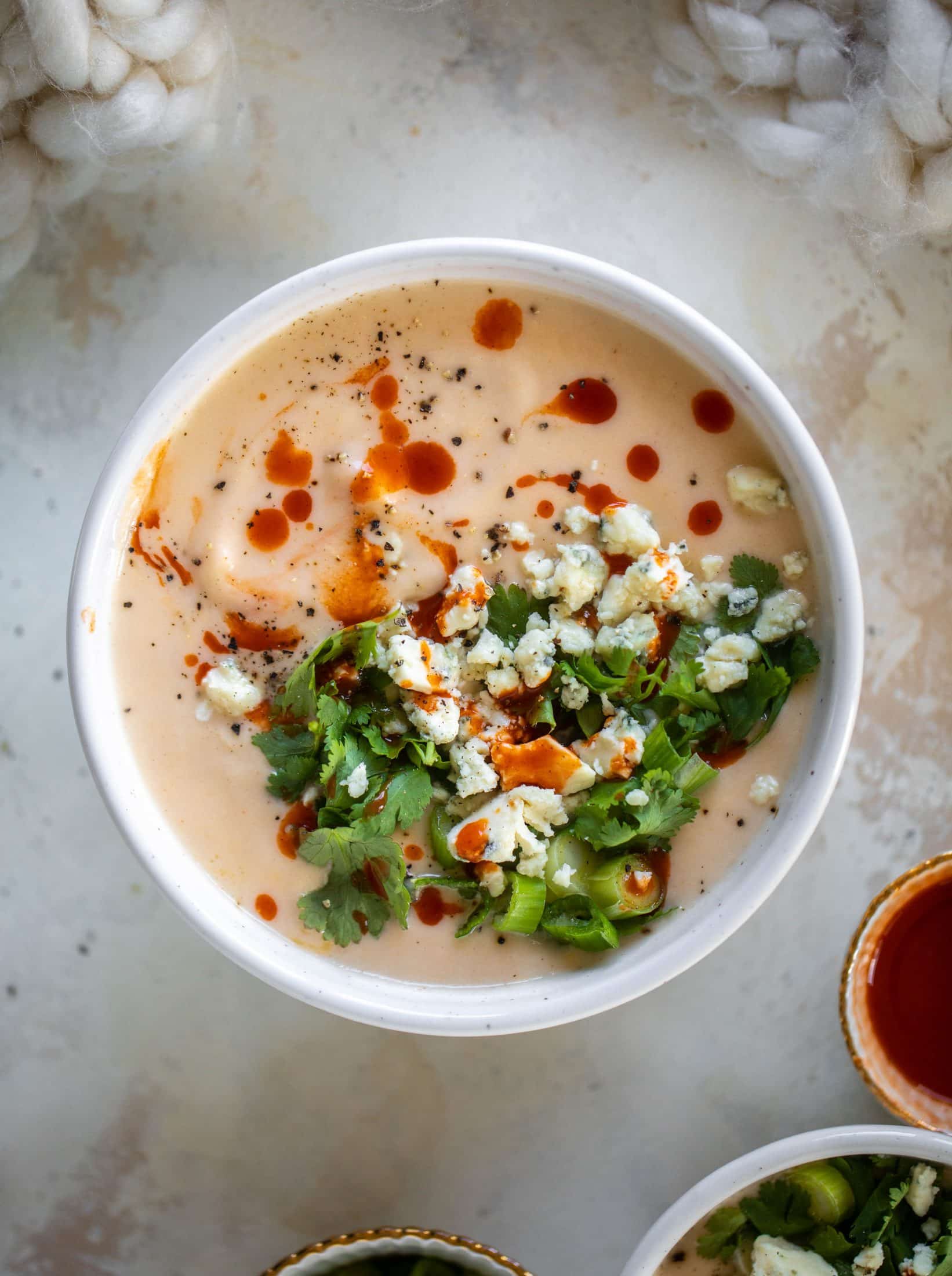 This buffalo cauliflower soup is creamy and decadent and silky smooth! Made with cheddar, wing sauce, blue cheese and all the fixins!
