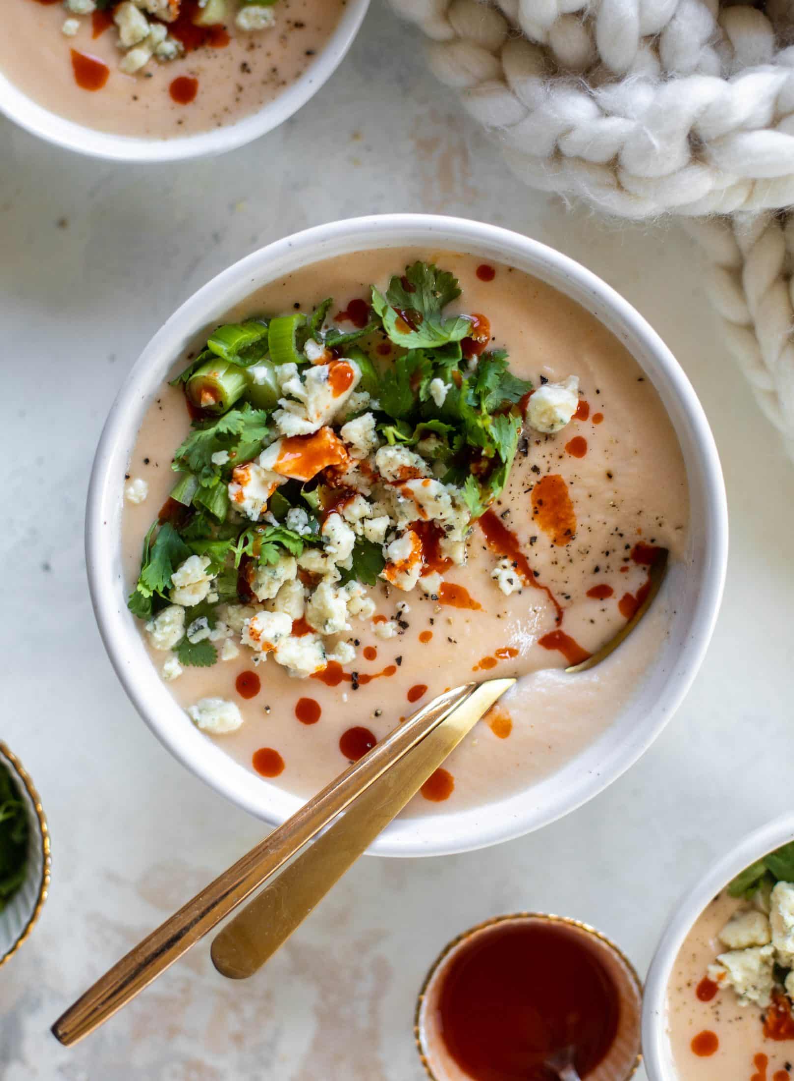 This buffalo cauliflower soup is creamy and decadent and silky smooth! Made with cheddar, wing sauce, blue cheese and all the fixins!