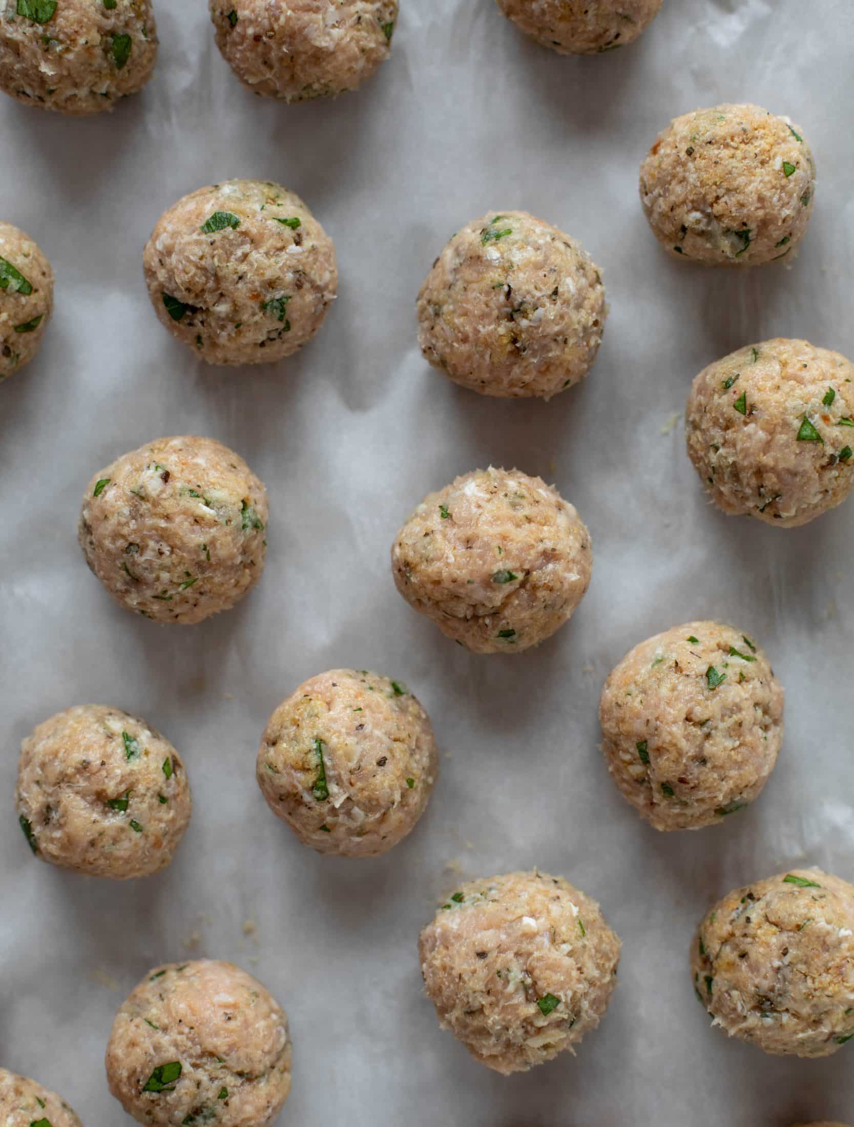 Chicken parmesan meatballs are baked and super flavorful! Serve with roasted garlic spaghetti for the best dinner ever! You can make them ahead of time too!