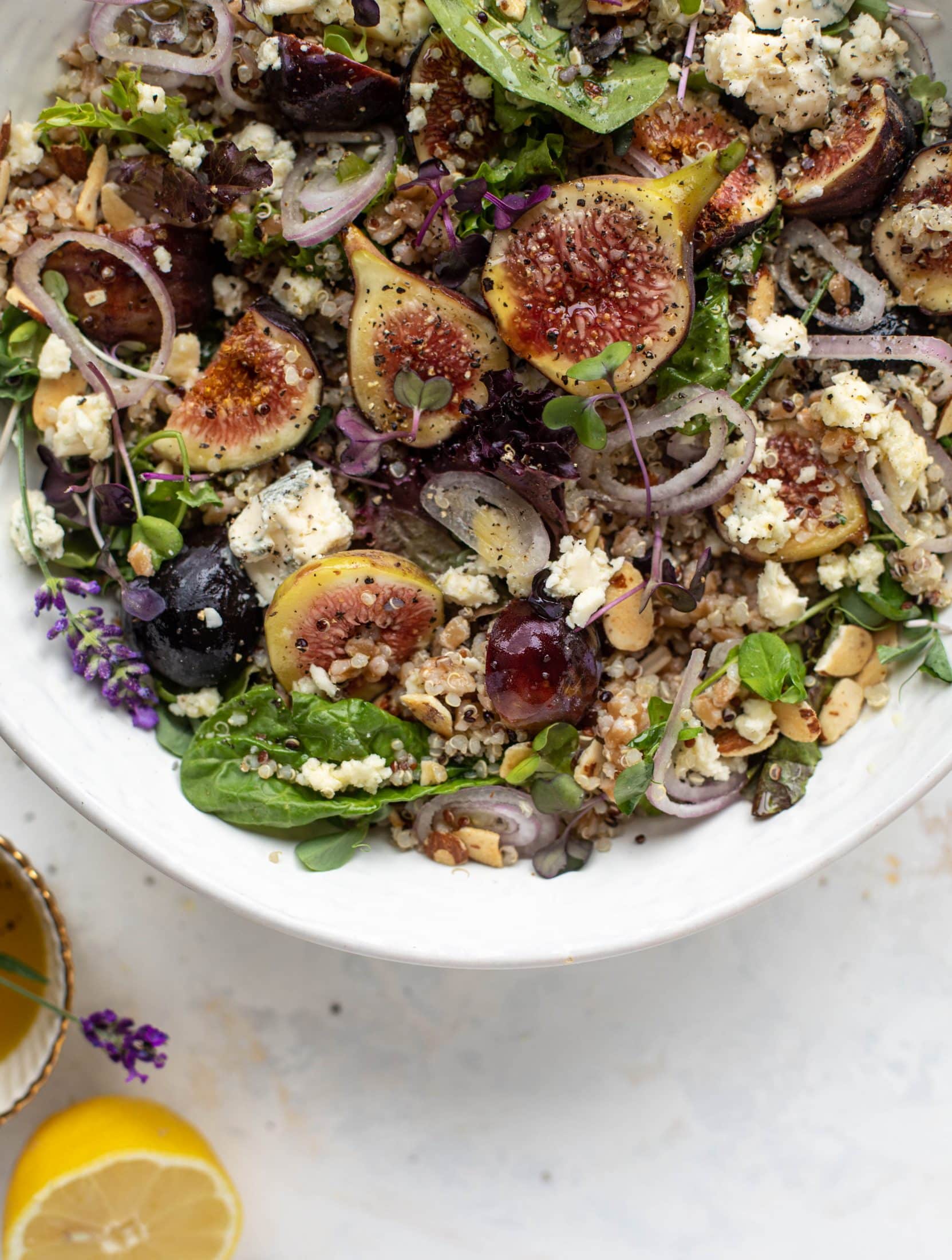 These grain bowls are the perfect September salad! Juicy figs, greens, quinoa, farro, almonds and a lemon lavender vinaigrette make this bowl irresistible.