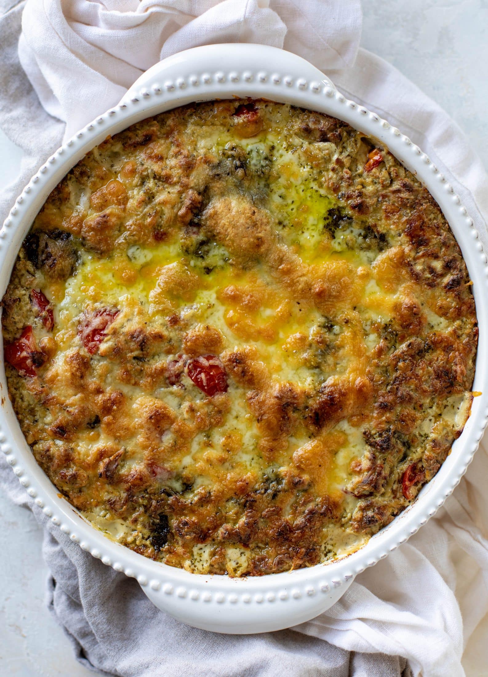 This cheesy pesto chicken dip is a great way to use up your end-of-summer herbs! Lots of delicious smoky flavor and tons of bubbly cheese.