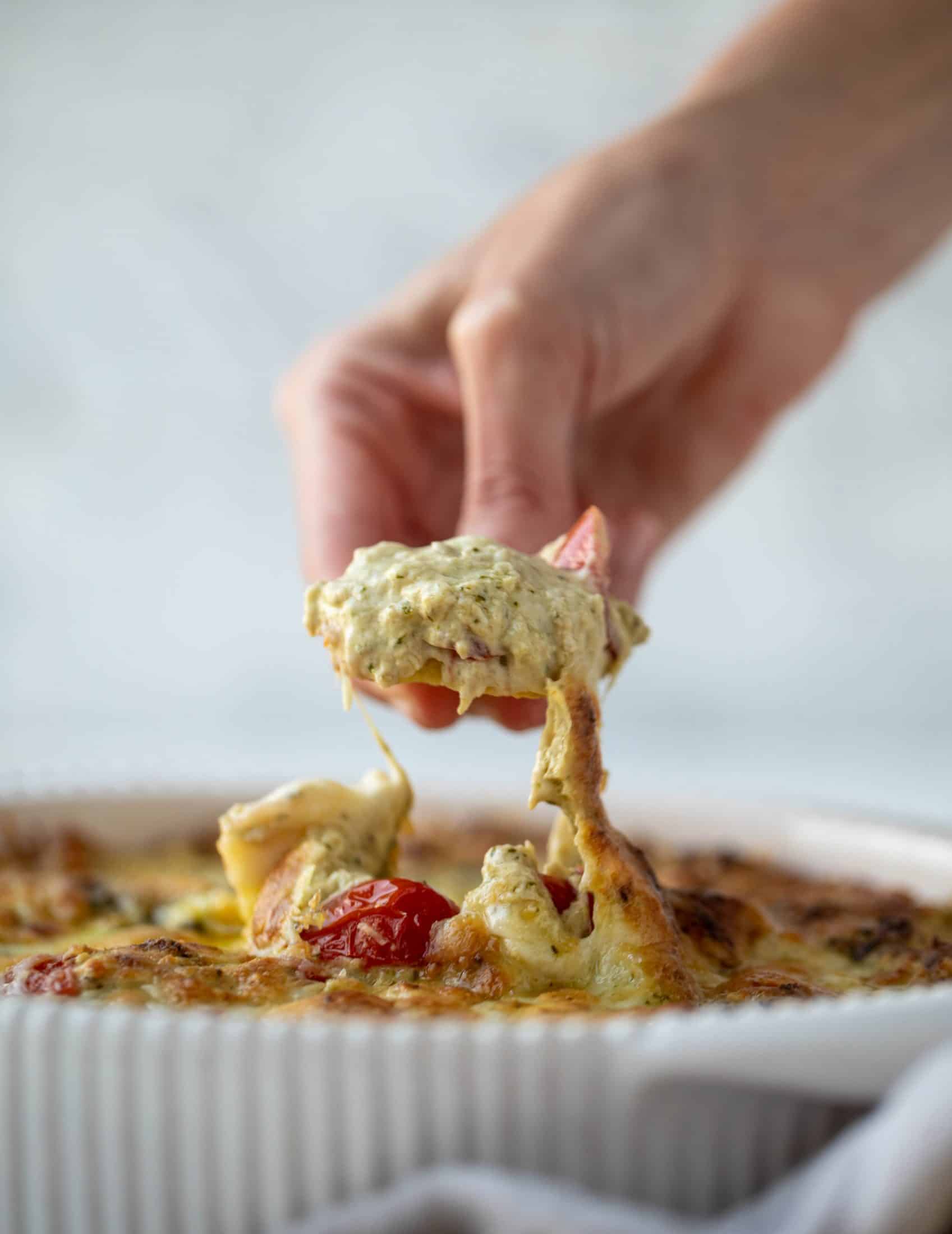 This cheesy pesto chicken dip is a great way to use up your end-of-summer herbs! Lots of delicious smoky flavor and tons of bubbly cheese.