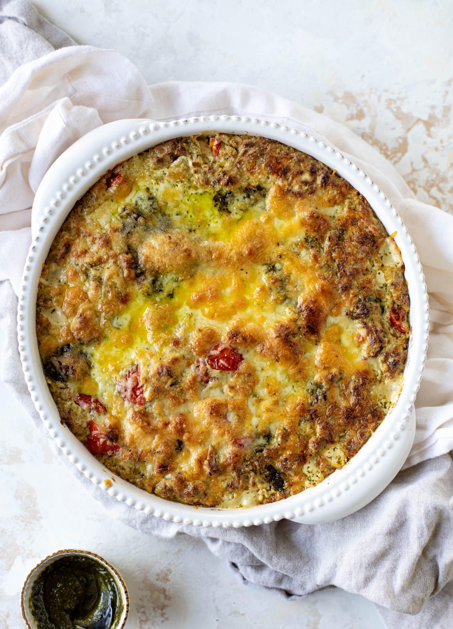 This cheesy pesto chicken dip is a great way to use up your end-of-summer herbs! Lots of delicious smoky flavor and tons of bubbly cheese.