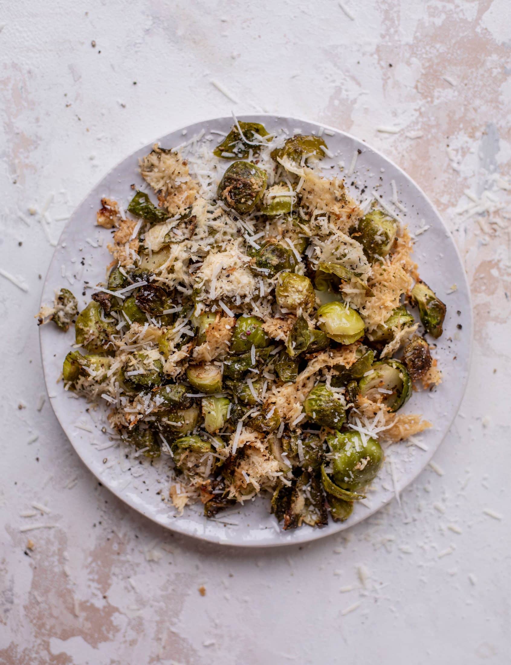 This cacio e pepe brussels are out of the world. Roasted until crisp, topped with tons of black pepper and salty pecorino cheese. Yum.
