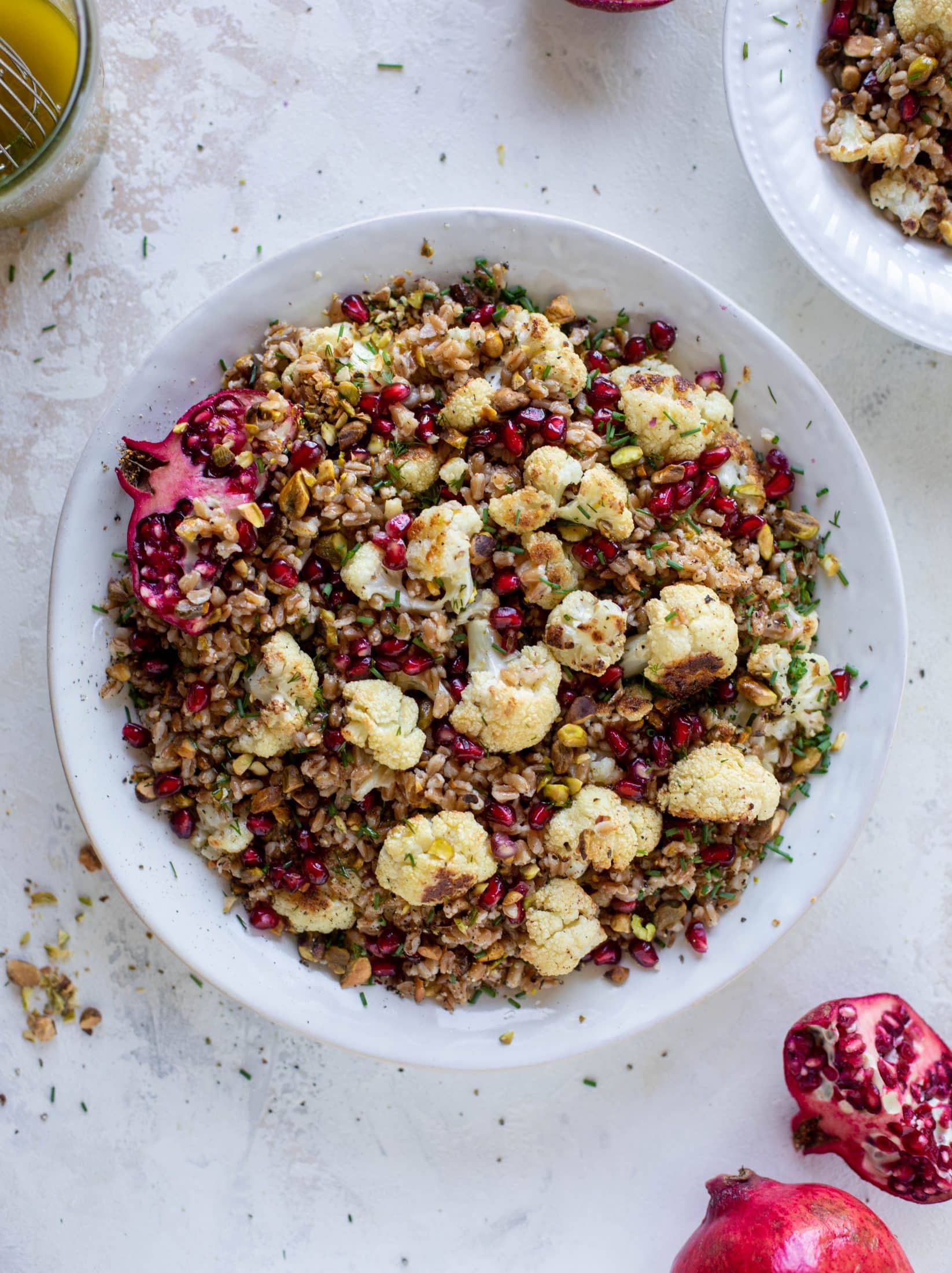 This cauliflower farro salad is filled with roasted cauliflower, pistachios, pomegranates and drizzled with a dill vinaigrette. Delicious!