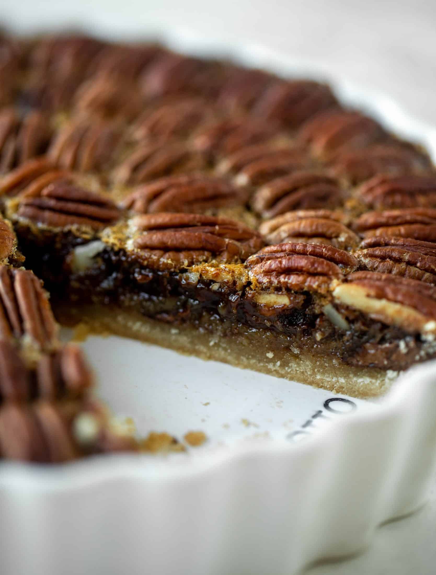 This chocolate pecan tart is the best dessert ever. Chocolate fudge and gooey pecan pie in a shortbread crust - everyone goes crazy!