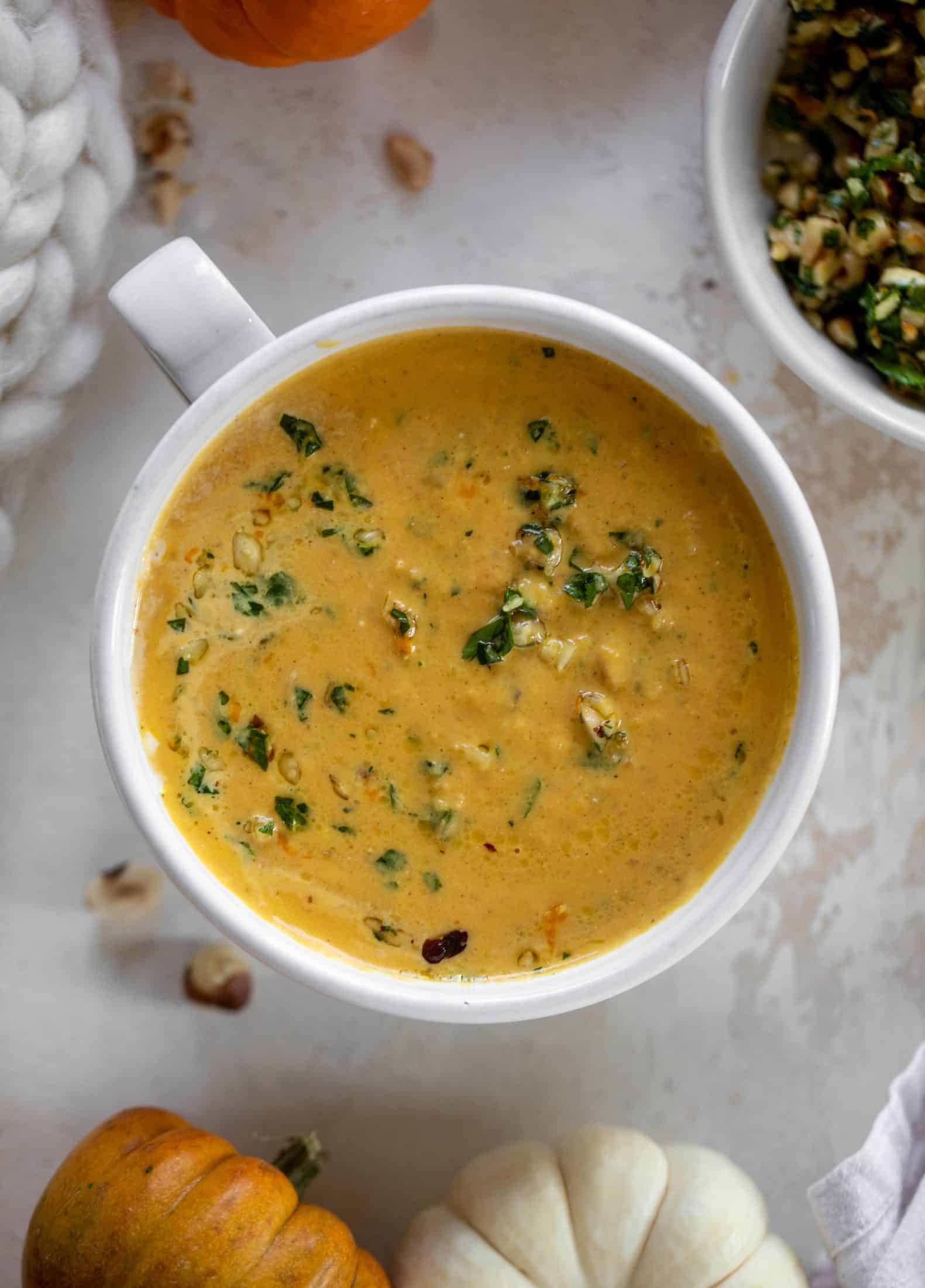 This pumpkin cream soup is silky smooth and delicious, then topped with a roasted hazelnut gremolata for extra flavor and crunch!