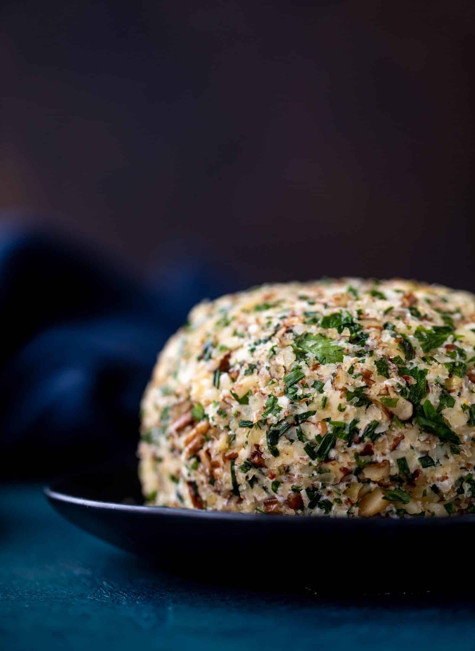 This macadamia nut cheeseball is flavored with fresh orange, spices, crispy sage and pecorino cheese. It's the perfect make-ahead snack!