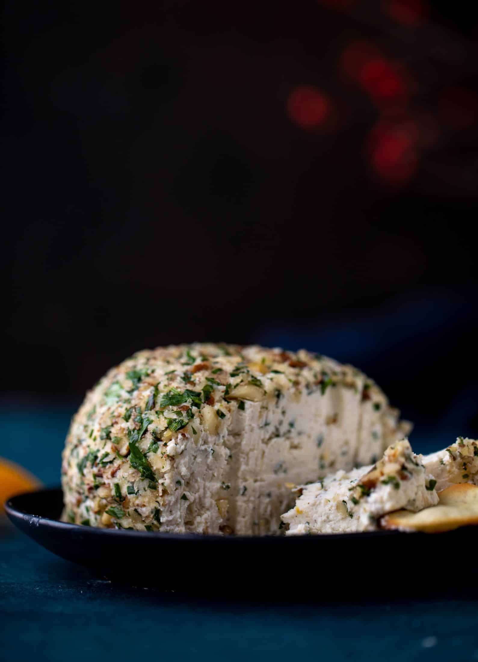 This macadamia nut cheeseball is flavored with fresh orange, spices, crispy sage and pecorino cheese. It's the perfect make-ahead snack!