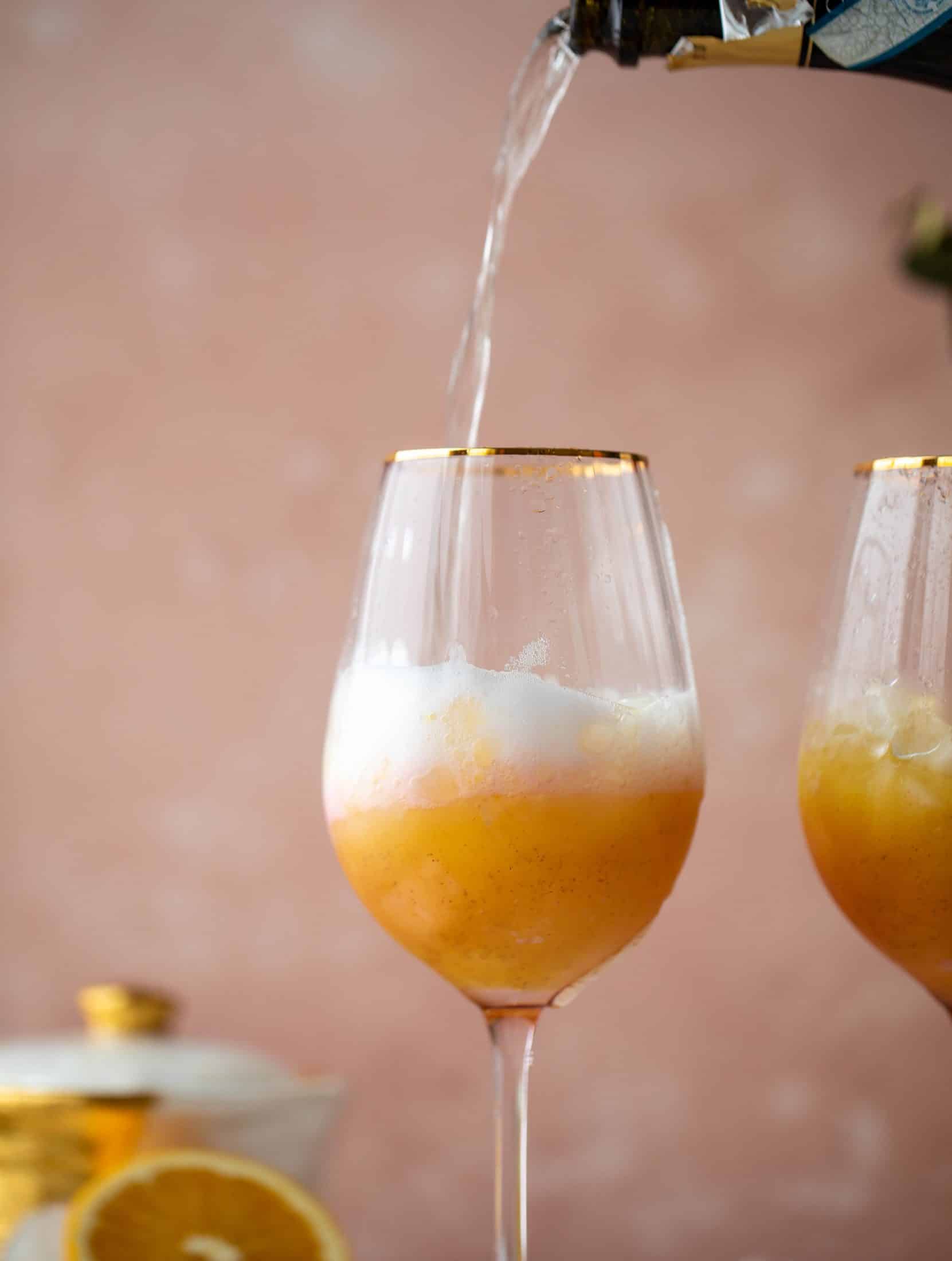 The spiced orange spritzer is a fancier mimosa and similar to an aperol spritz! A fresh spiced orange juice based mixed with prosecco and seltzer. So good!
