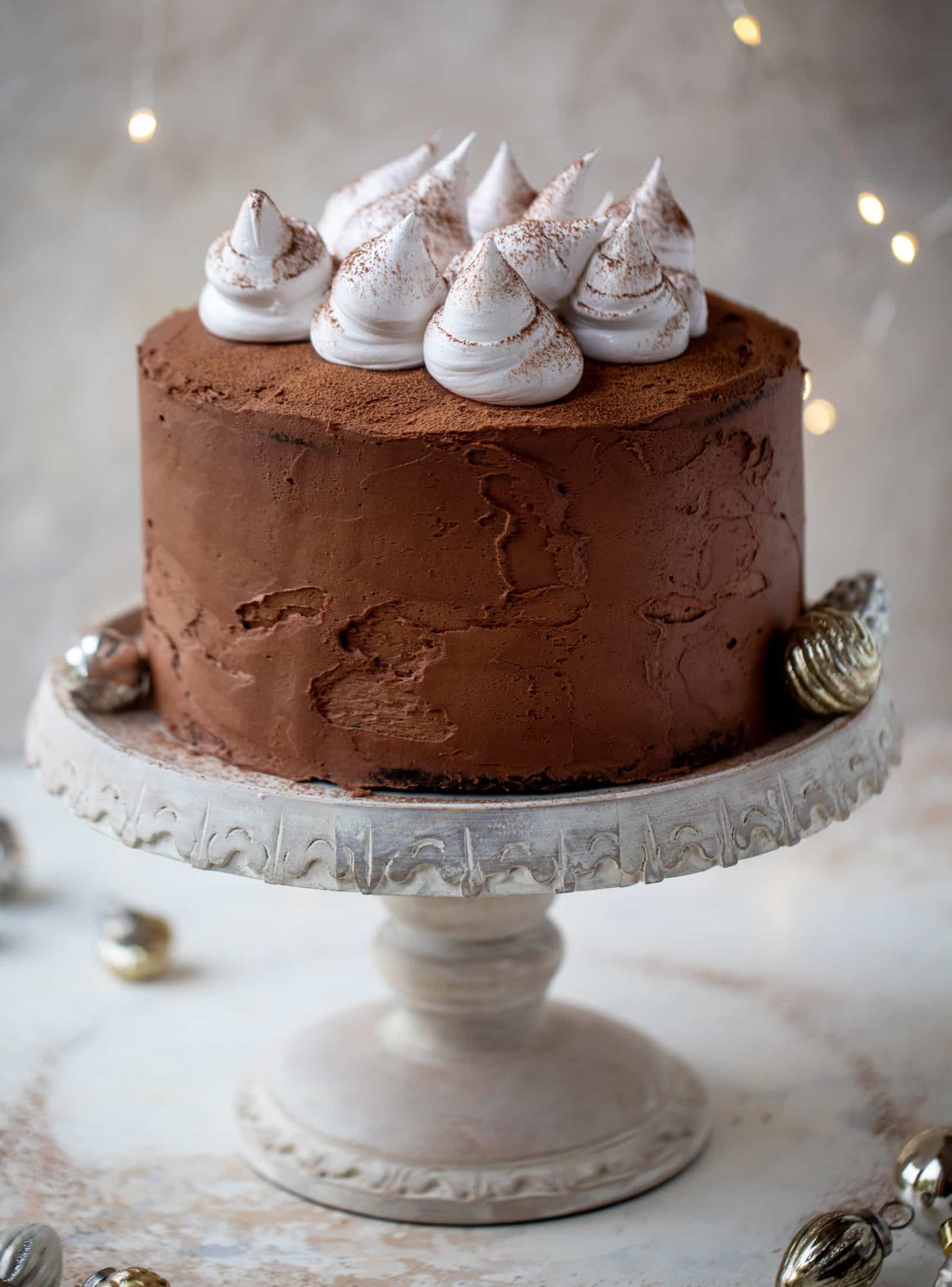 This hot cocoa cake is made with the fudgiest chocolate cake, smothered in chocolate cream cheese frosting and dolloped with whipped marshmallow!