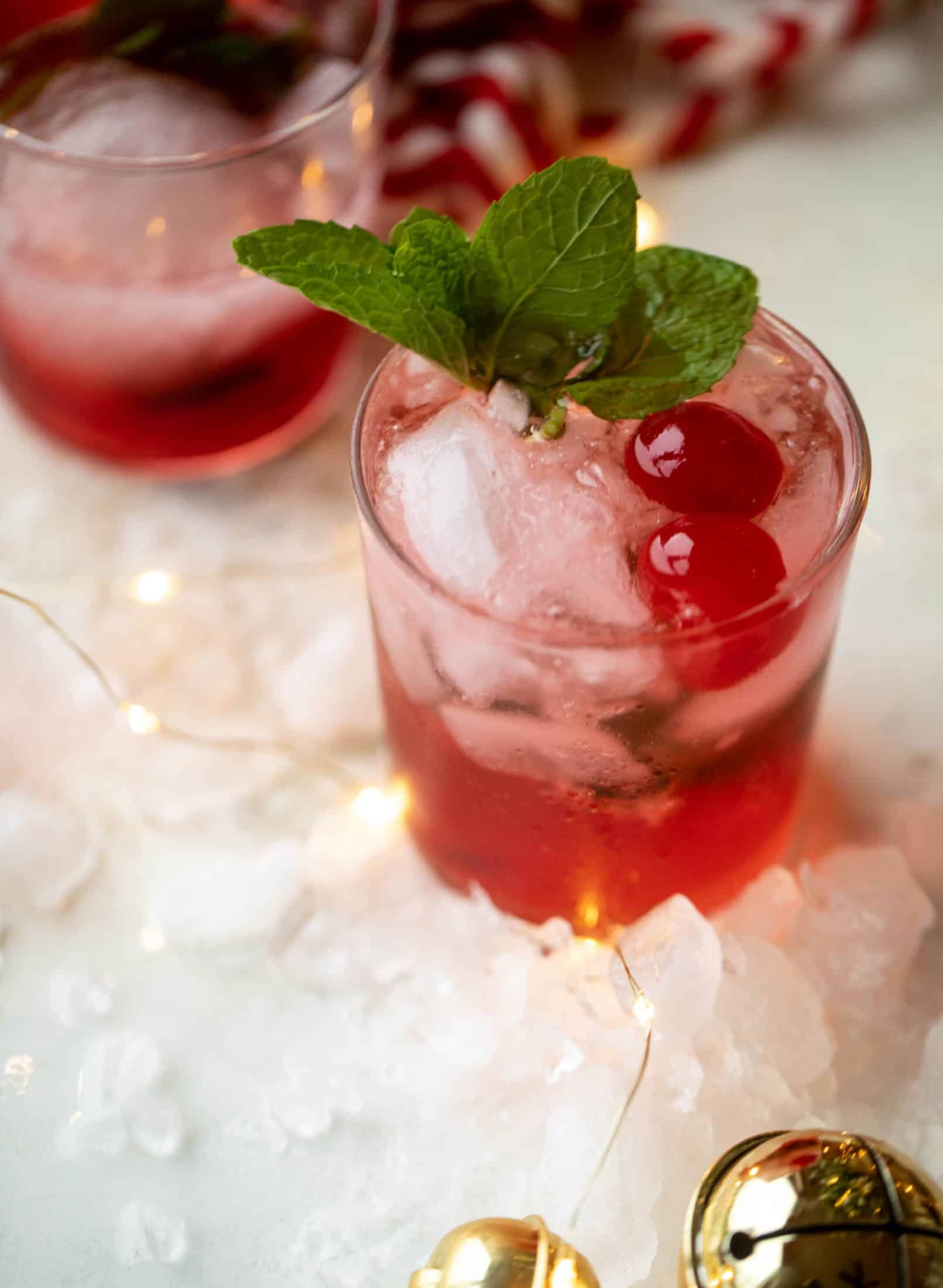 The merry cherry christmas cocktail is here! Vodka and cherries and mint, oh my! This is such a fun drink that can be made into a punch. It's delicious!