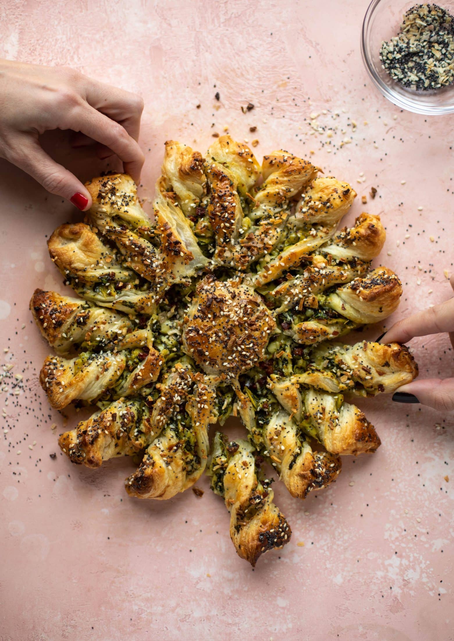 These spinach artichoke twists are filled with cheese and pancetta. They are buttery and flaky on the outside then sprinkled with everything seasoning. YUM.