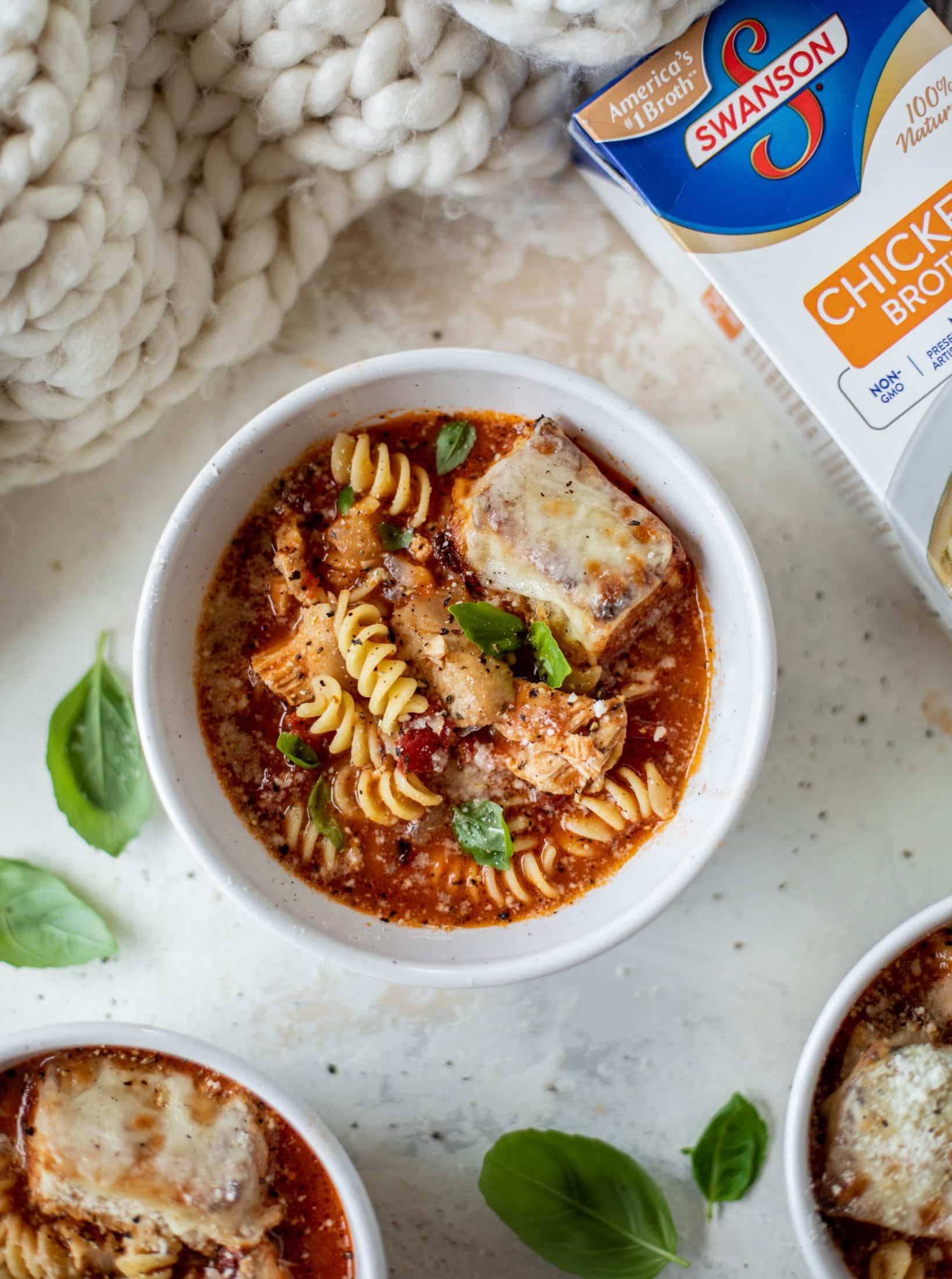 This chicken parmesan soup is ridiculously flavorful and so easy to make! Juicy chicken with pasta, fire roasted tomatoes and mozzarella croutons. Yum!