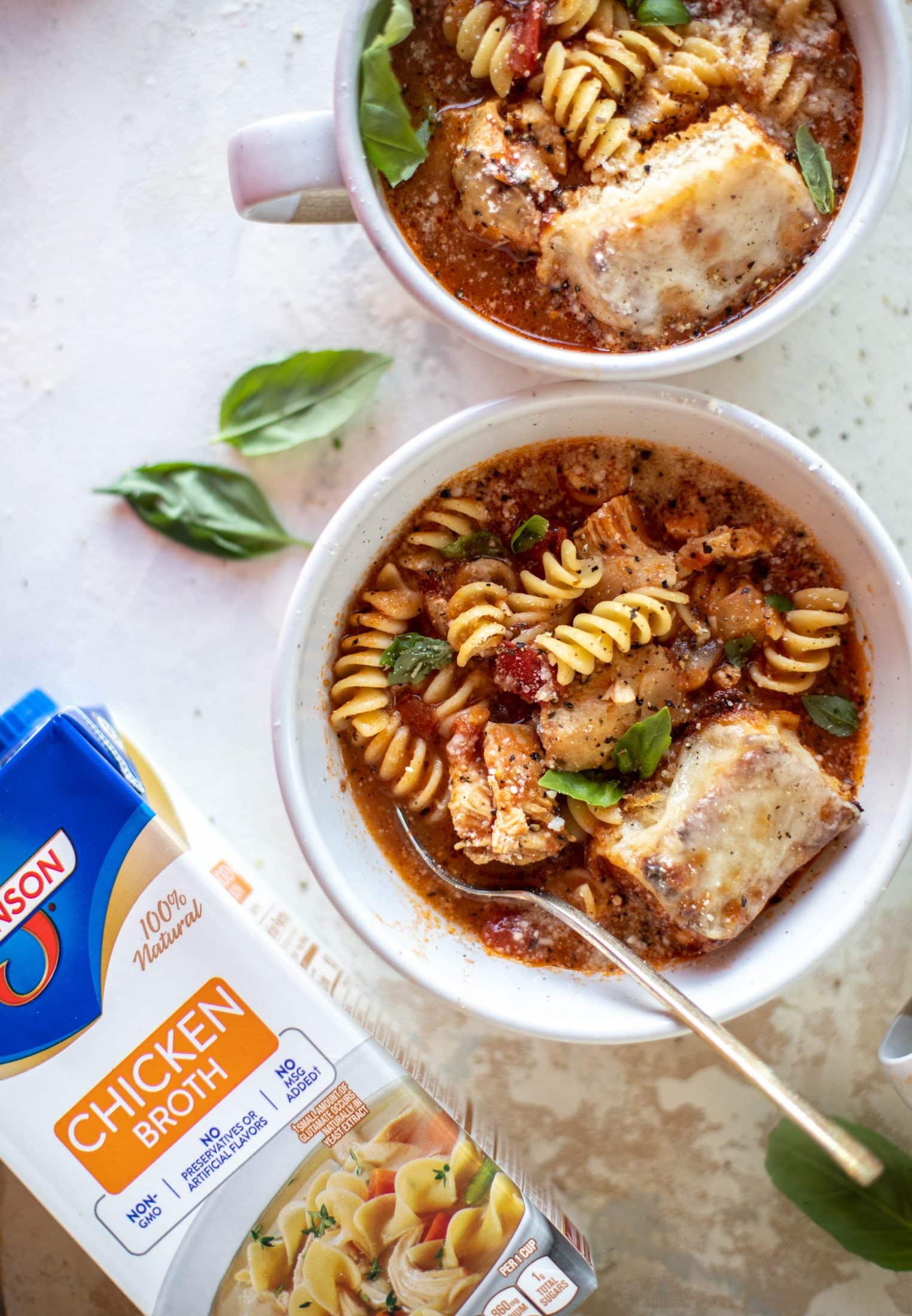 This chicken parmesan soup is ridiculously flavorful and so easy to make! Juicy chicken with pasta, fire roasted tomatoes and mozzarella croutons. Yum!